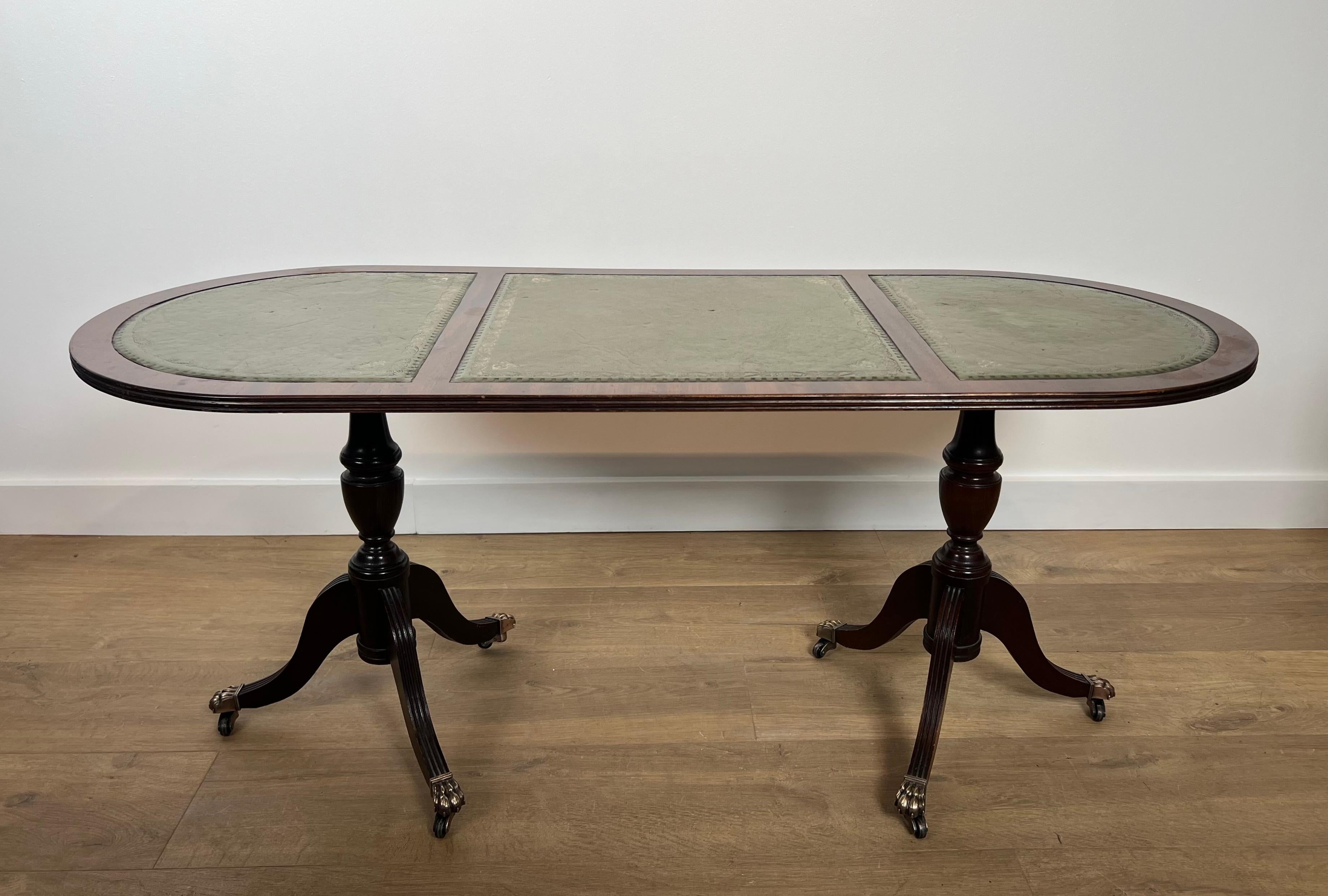 Cette belle table basse est en bois avec des pieds griffes en bronze et un plateau en cuir vert. Il s'agit d'un ouvrage français. Circa 1940