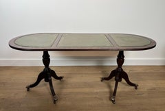 Wooden coffee table with bronze claw feet and green leather on Top