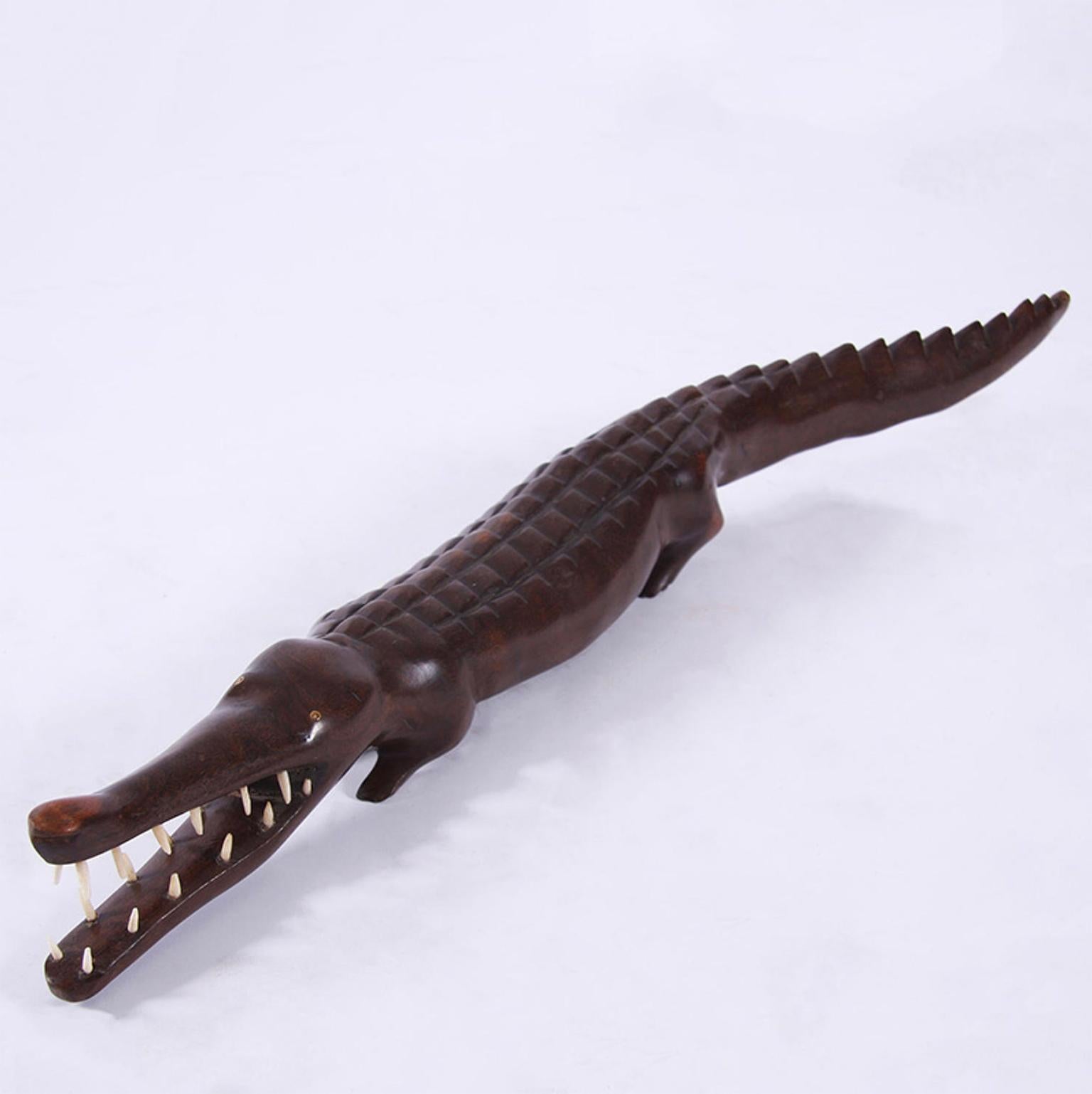 A super sweet wooden crocodile with mouth wide open to reveal teeth.