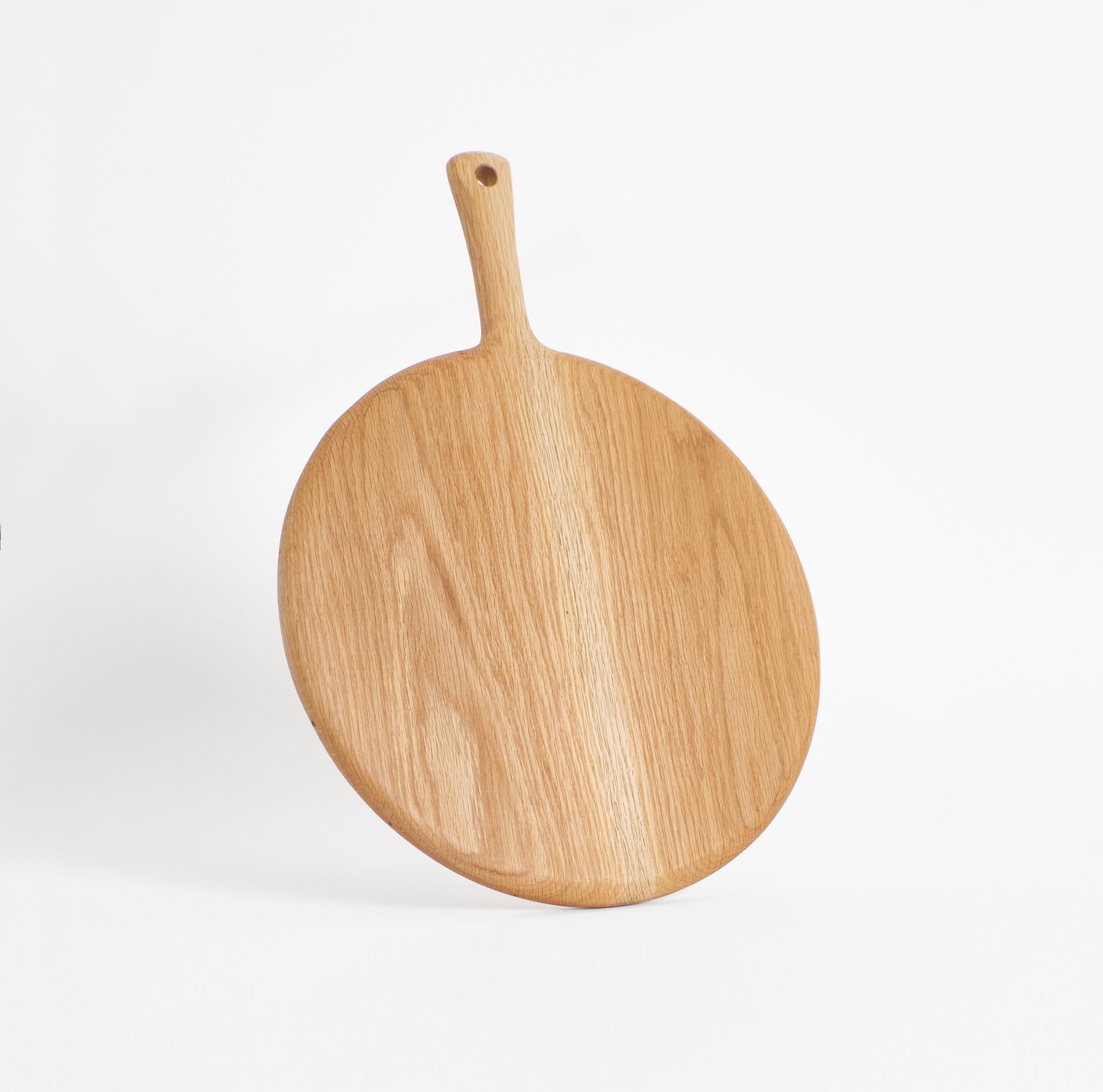 Hand-made wooden board

This large round board is hand-carved from oak. The boards as an individual or as part of the family will become a key item in every kitchen being decorative as well as functional. 
Available in three other sizes and wood