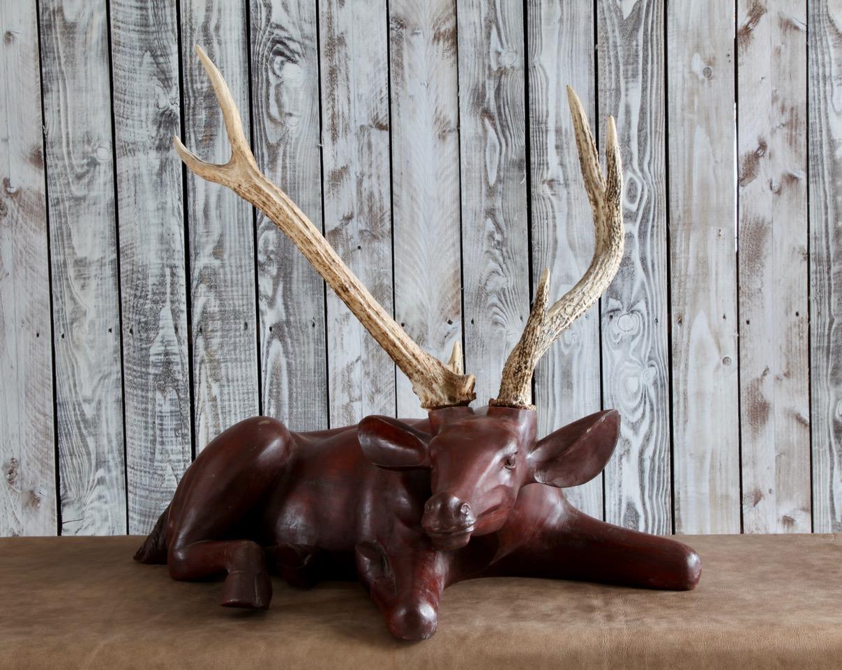 Decorative deer made from solid wood with real antlers.
