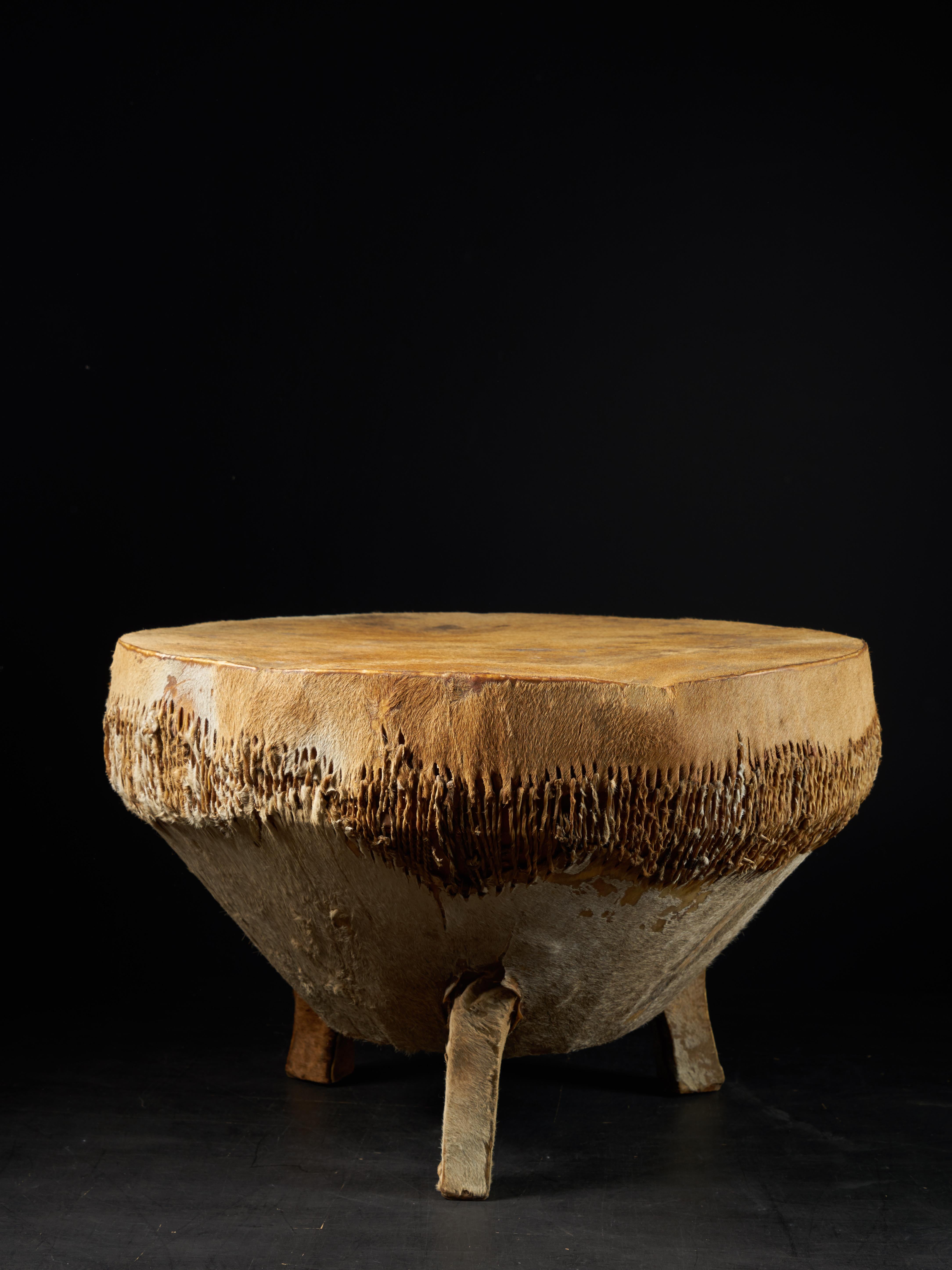 This Ingoma drum is covered with a membrane of animal skin. The drum is usually cylindrical in form and the top broader than the bottom it originates from the Tutsi people, an ethic group living within Rwanda and Burundi. The Tutsi formed the