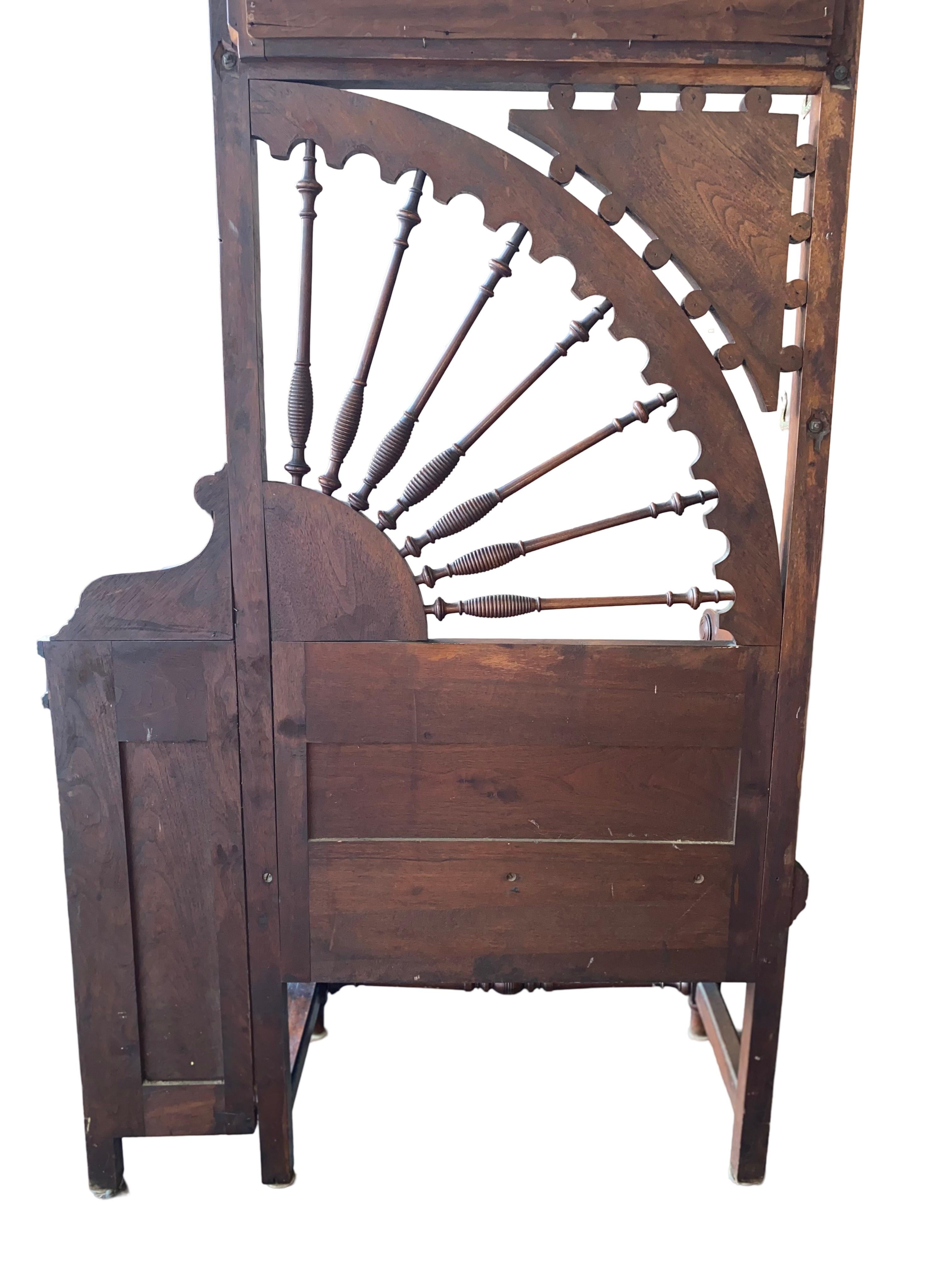 Step into the elegance of the Edwardian era with this stunning hall tree, crafted circa 1900. Showcasing exquisite Art Nouveau carvings, this piece is a harmonious blend of beauty and function. The open side panel features a graceful fan-shaped