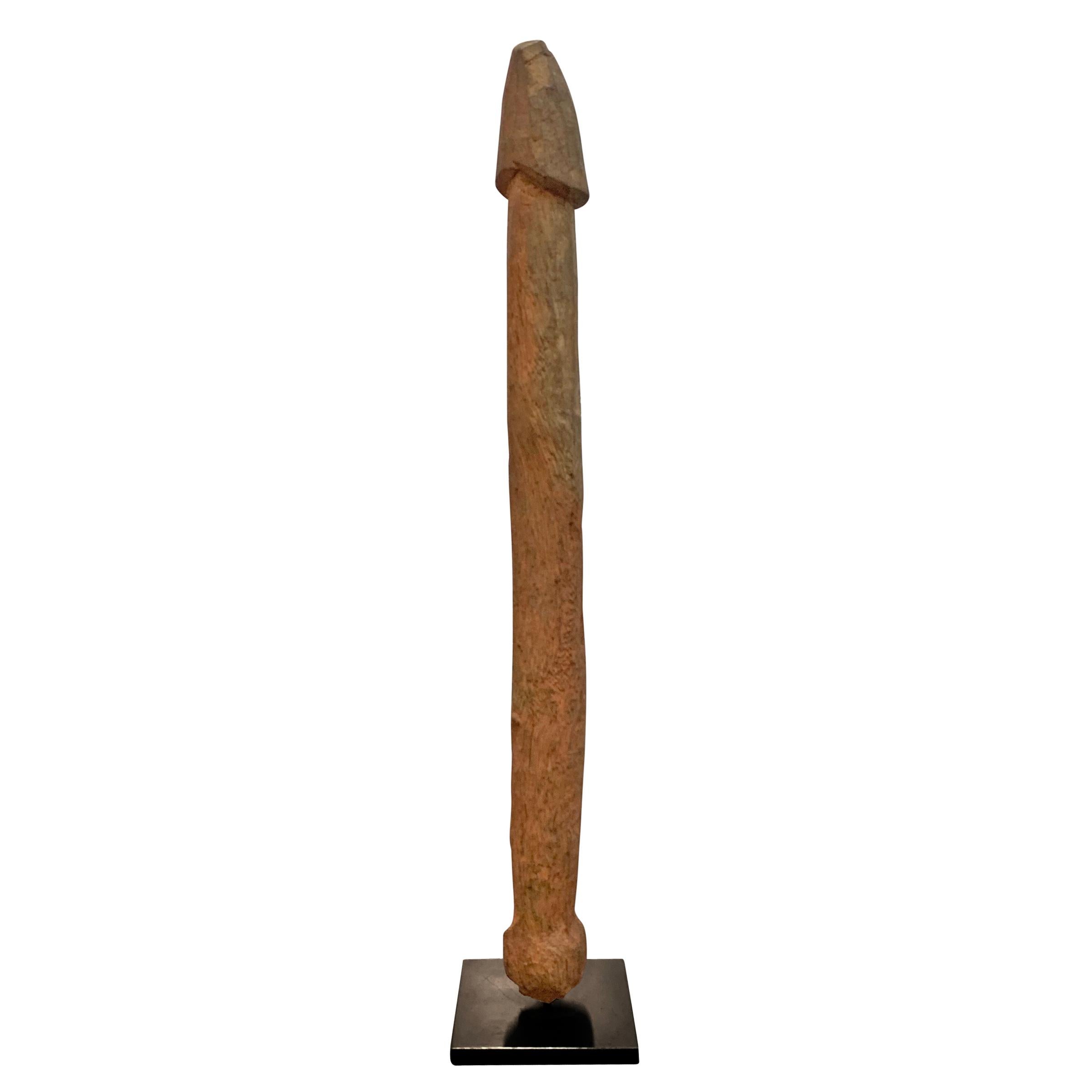 A wonderful early 20th century Fon wooden phallus fertility figure mounted on custom steel stand. Phallus figures like these were placed into the dirt of a farmer's field as an offering for a fertile and abundant crop. This piece shows lots of wear