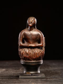 Wooden folk-art figure, depicting a stylized feminine Soul burning in Purgatory.
