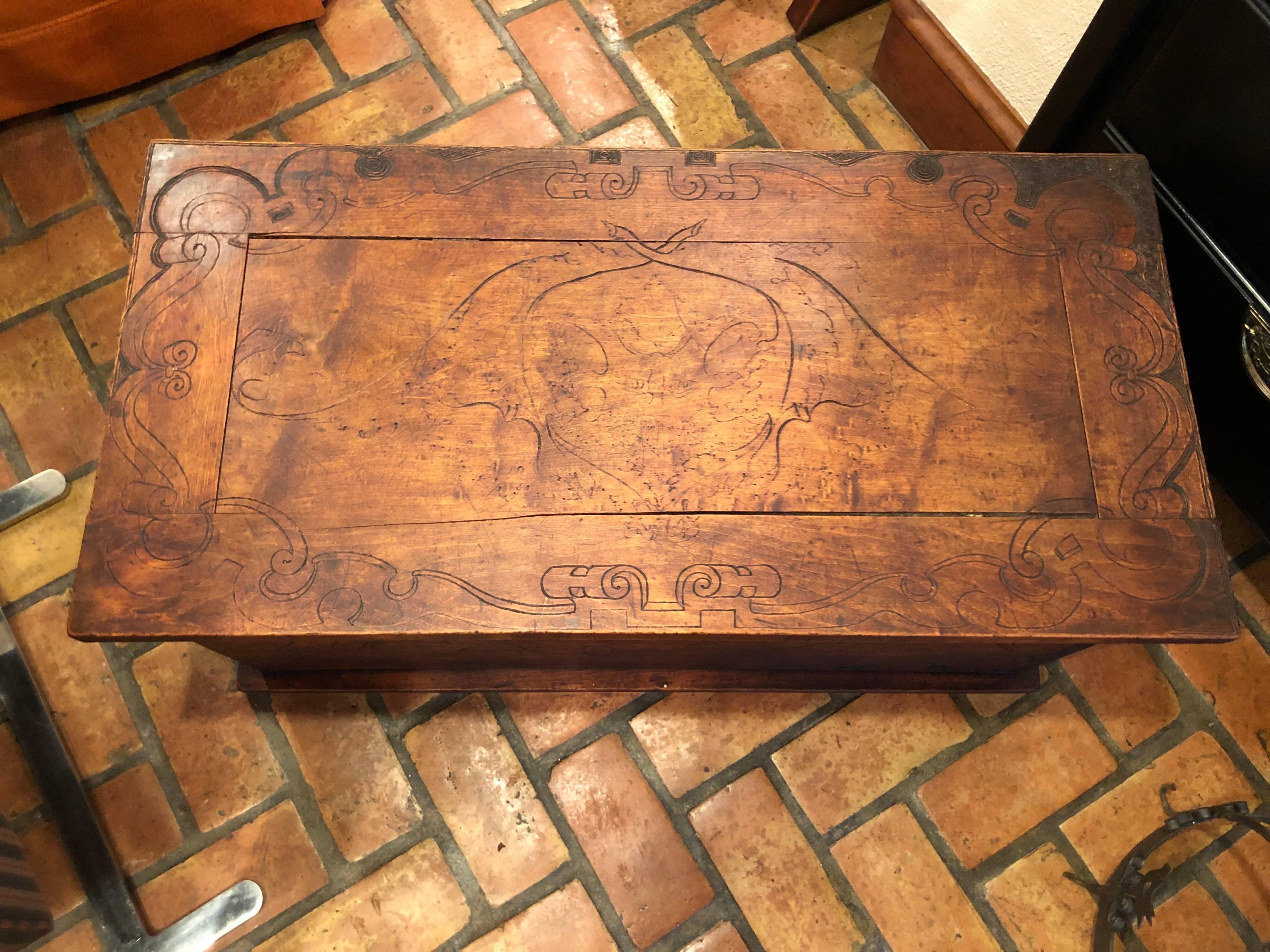 Wooden Folk Art pyrography trunk. Intricately burned and carved back and sides make up this beauty. The front has no decoration but the hinged top could be switched to fix that. All in all a gorgeous unique storage piece for either blankets or even