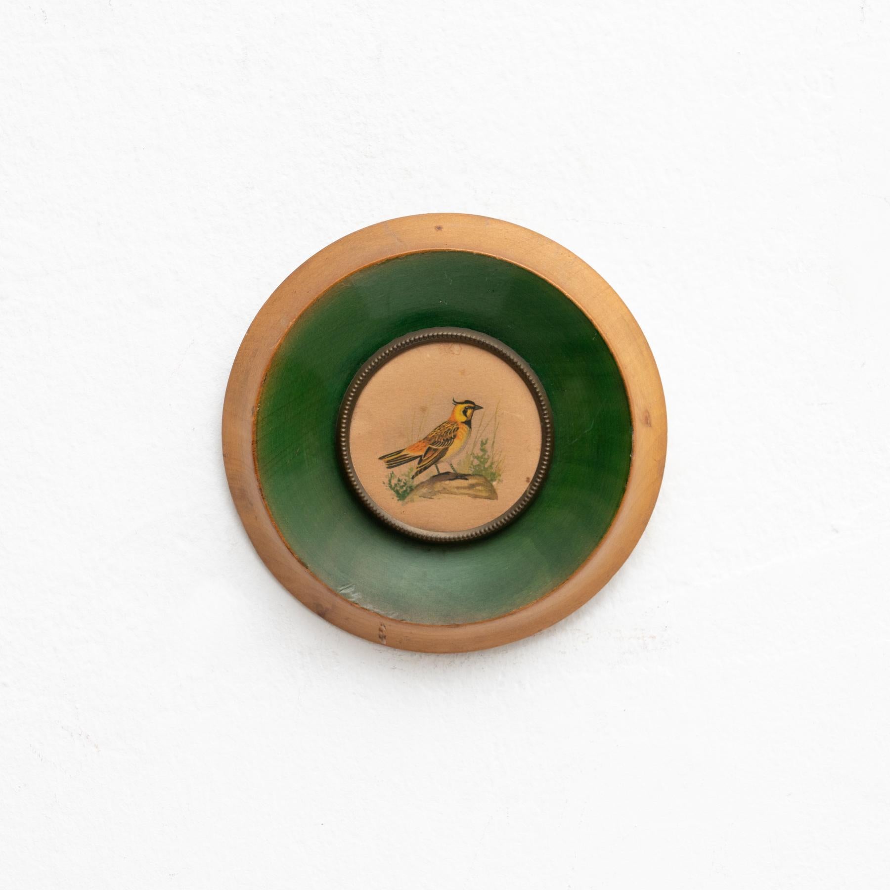 Round framed hand painted artwork of a bird design by unknown artist, circa 1960.

In original condition, with minor wear consistent of age and use, preserving a beautiul patina.

Material:
Wood.