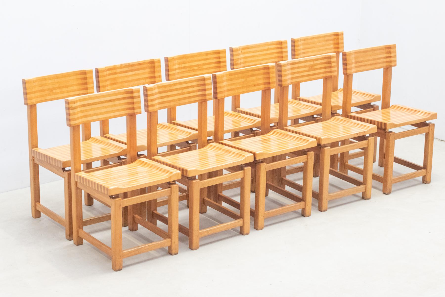 Set of 10 multilayer solid wooden chairs from France, 1970s. 
 The seats and backs of these chairs are a testament to meticulous craftsmanship and artistic ingenuity. Crafted from two solid woods in contrasting colors, the multi-layered designs add