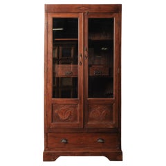 Wooden Glass-Front Cabinet with Carved Panels and Interior Drawers