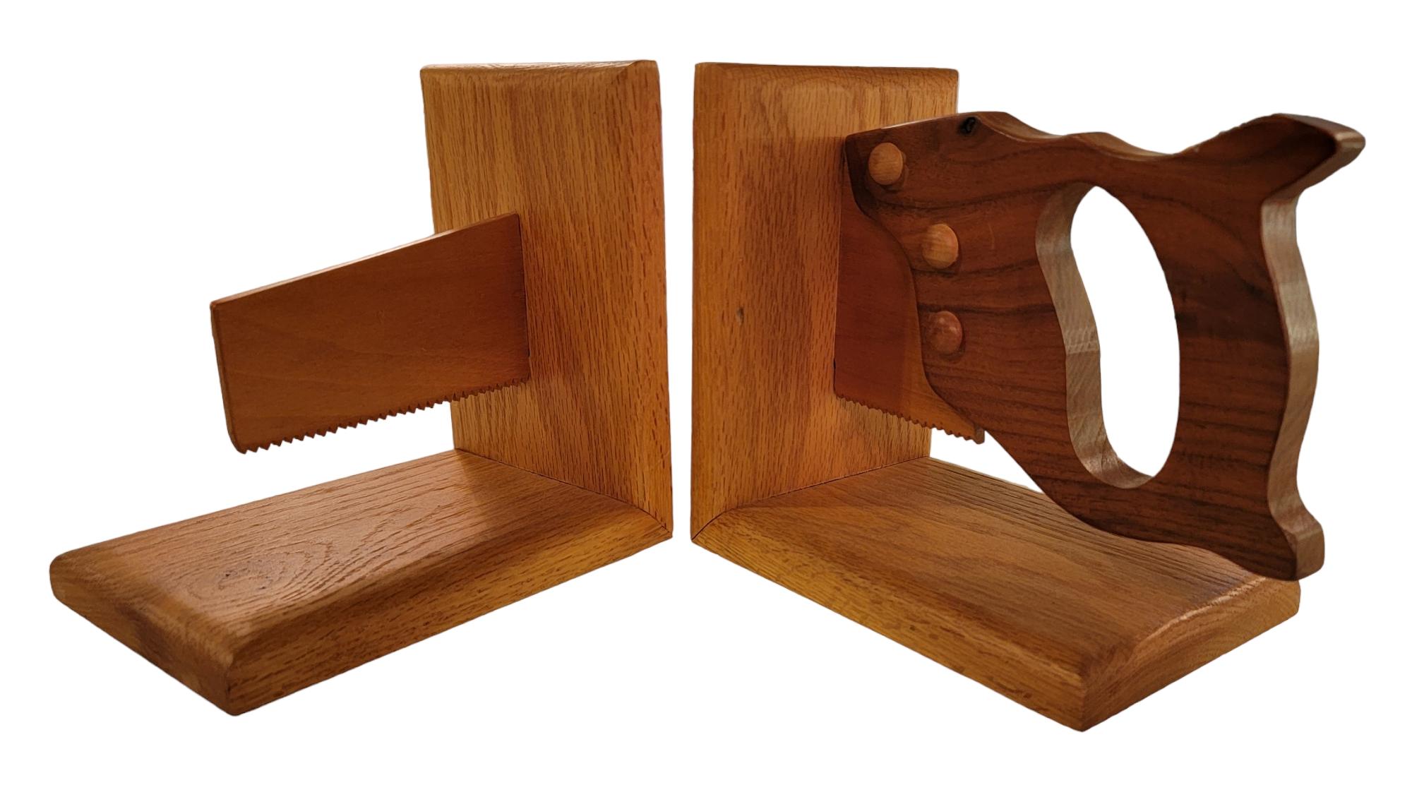 Wooden Hand Made Hand Saw Bookends. wonderful scale to the saw and handle. Beautiful wooden grain. Great for a handy man reader or as a great decorative piece. 
