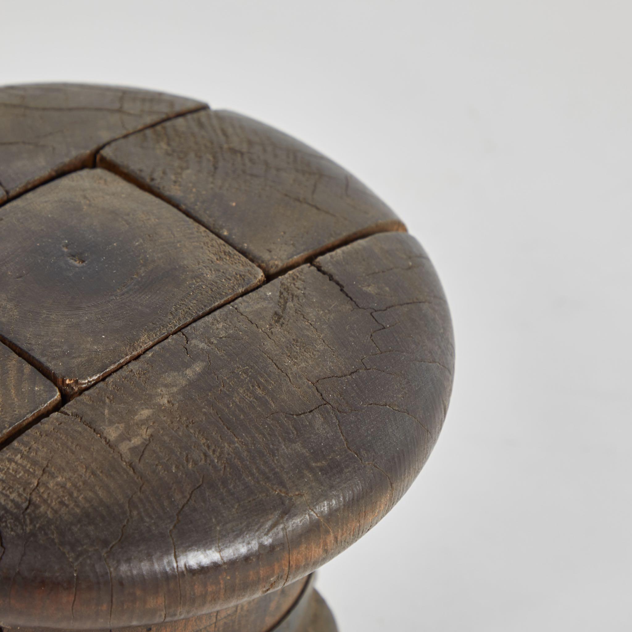 Wooden millinery hat block from early 20th-century France. The button-like structure has been carved from five separate joints of wood, resulting in an interesting, puzzle-like surface. A sculptural decorative accent for any table or shelf-scape.