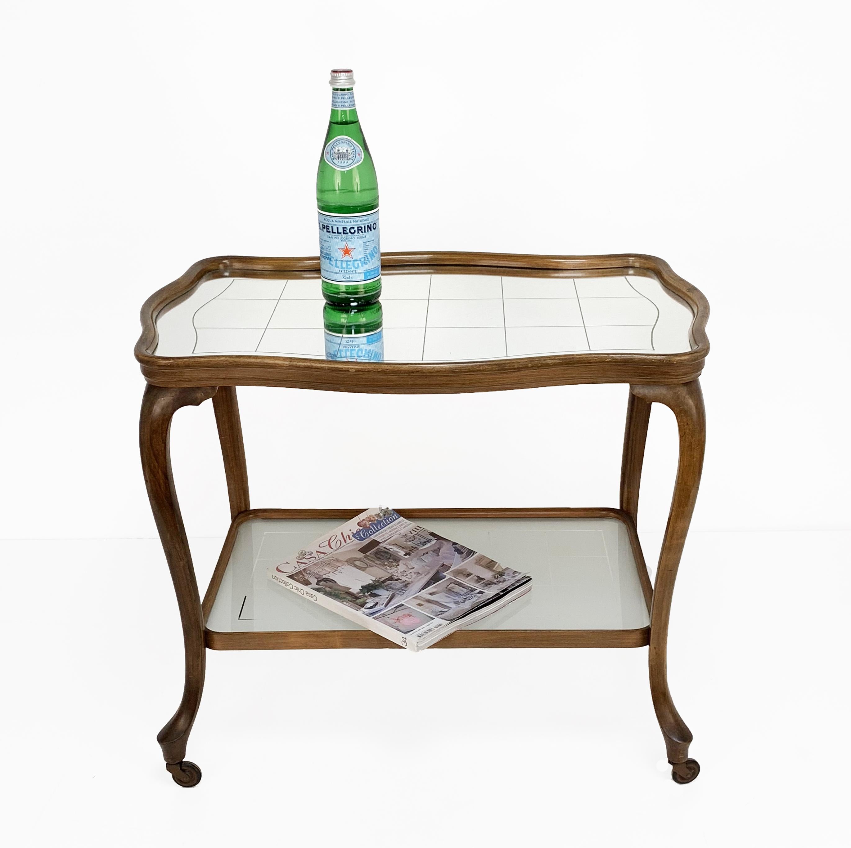 Very elegant Louis XV style bar trolley in oak wood, mirror top. France, circa 1930.
The upper floor is in mirror with squares, the lower floor is made of sarin glass.