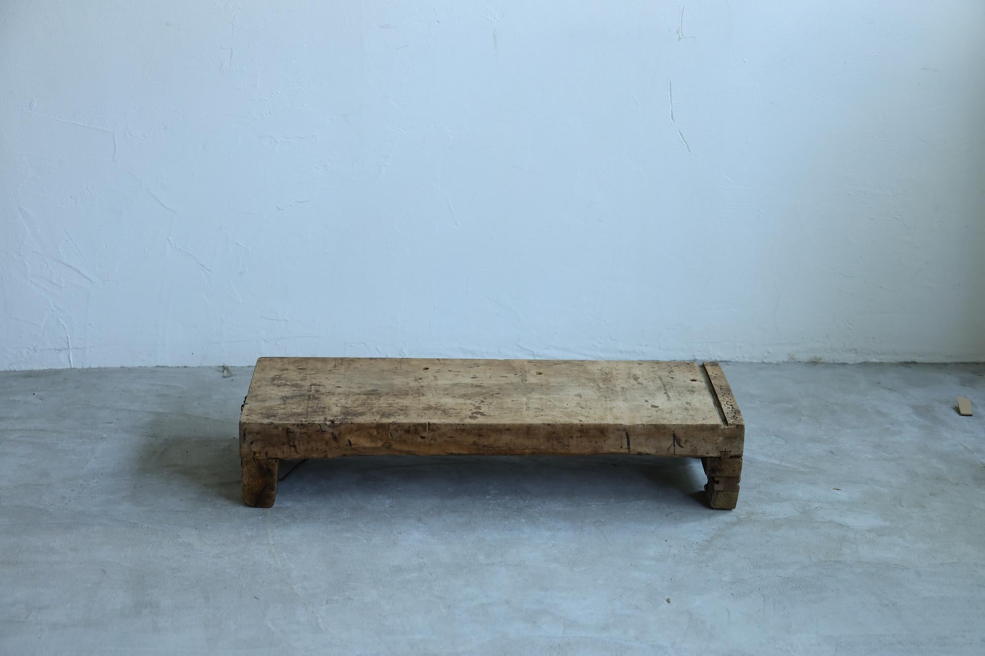 Introducing our unique low table, a stunning testament to the beauty of wabi-sabi and craftsmanship. Originally used as a workbench by furniture artisans, this piece showcases the rich history of countless tasks performed on its surface.

Made from