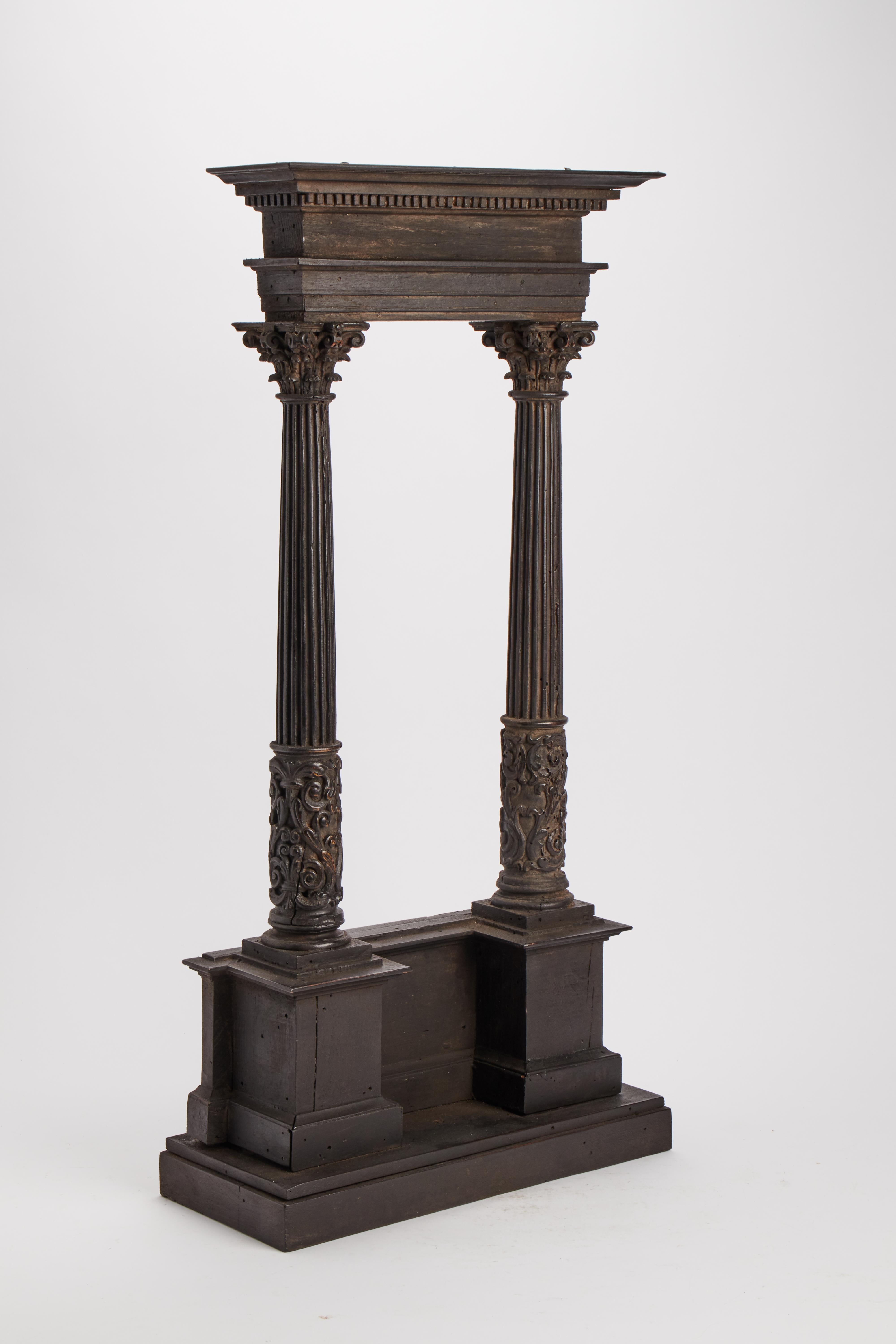 Wooden maquette for Wunderkammer, of an architectural model depicting two columns with Corinthian capitals holding up an entablature. Several fruitwood species, original patina. Italy mid-17th century.