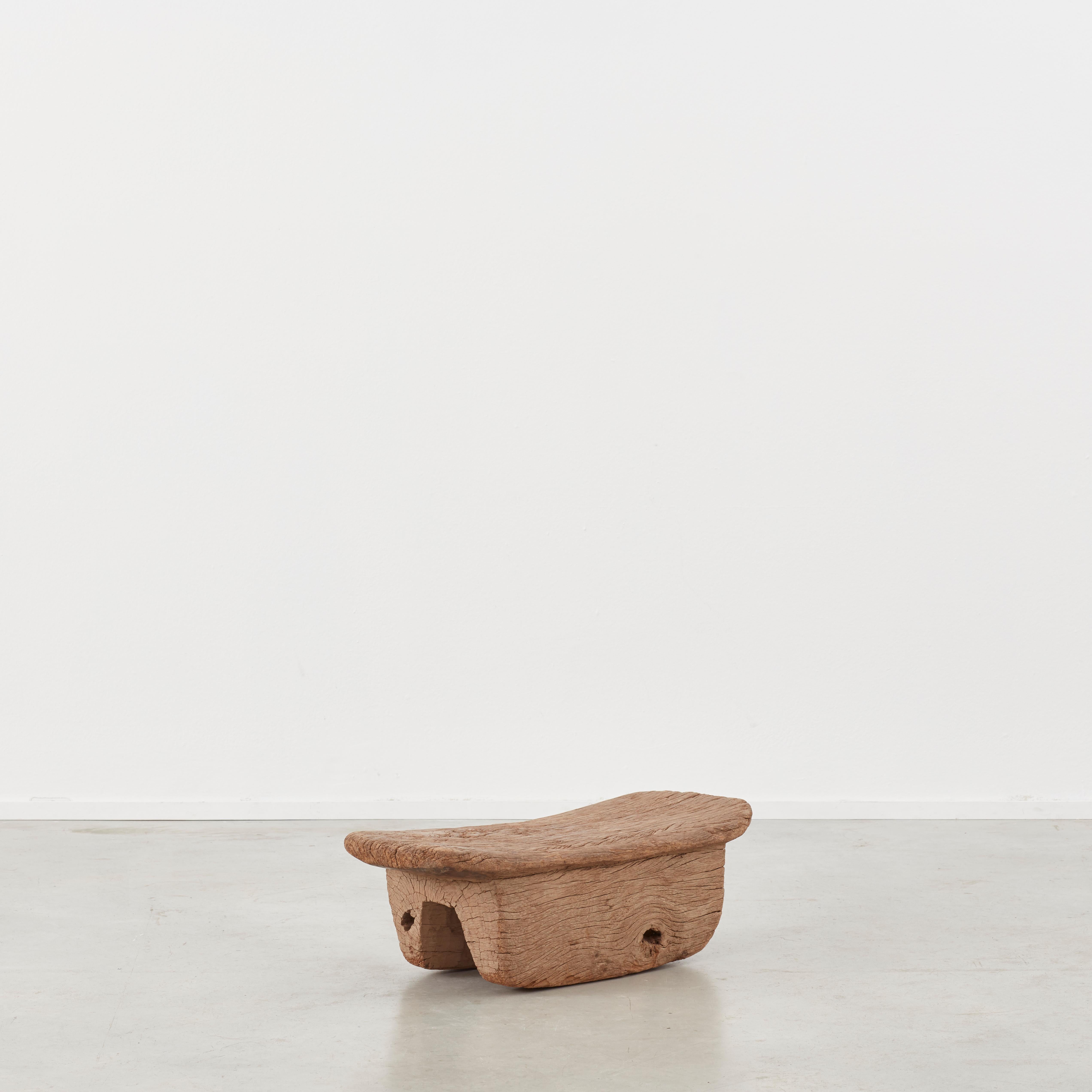 This ancient meditation stool is crafted from a lovely weathered piece of hardwood. Its simple form is given life by the depth of grain, surface cracks and patina throughout. It would lend itself well to being used for a wide array of interior and