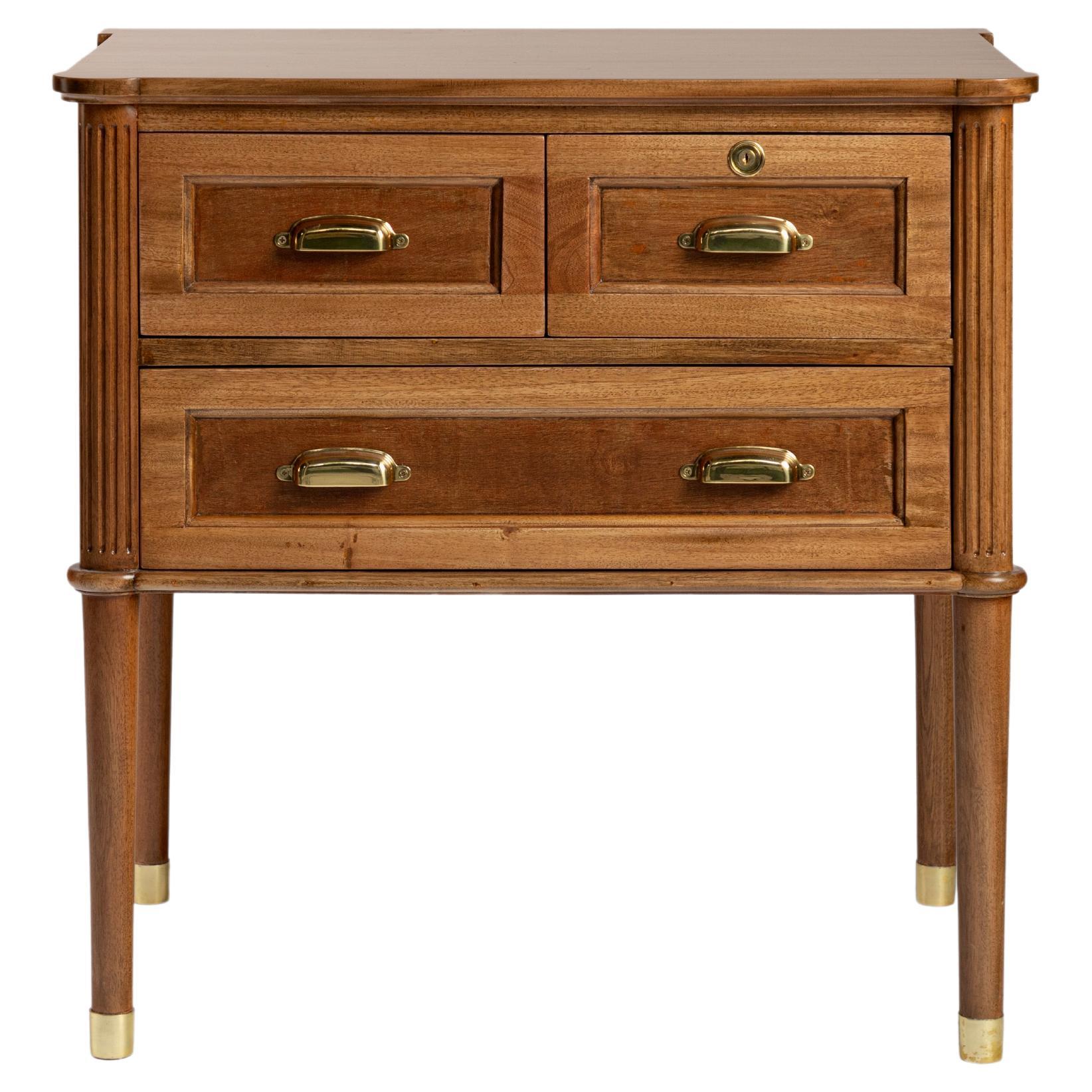 Wooden nightstand with brass handles and leg caps For Sale