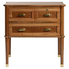 Wooden nightstand with brass handles and leg caps