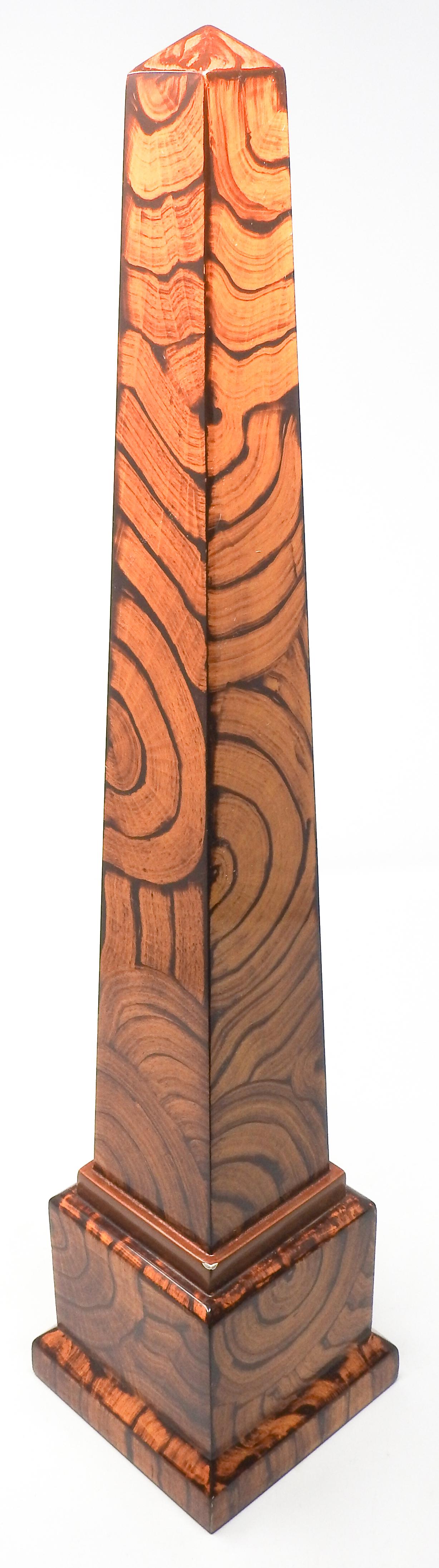 A very nicely scaled and constructed wood obelisk. The woods chosen to complete this piece is very figured and beautifully stained in partial circles to add texture and give a manly and timeless element to the pair.
