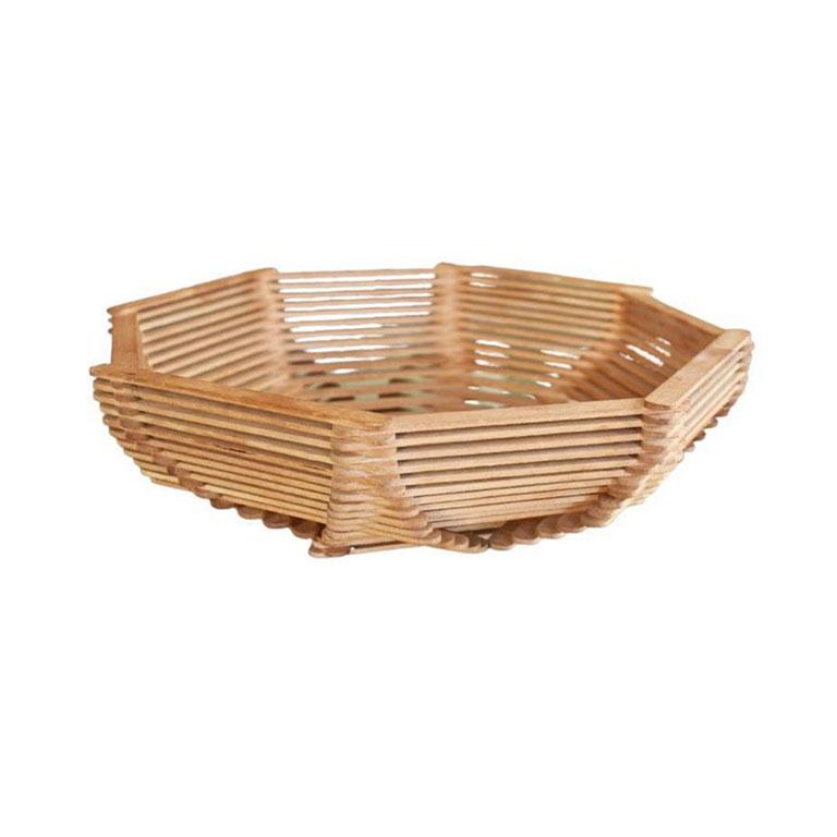 An octagonal decorative wooden tramp art basket. Created from popsicle sticks, this basket is lightweight, perfect for holding remotes or other odds and ends on a coffee table, or even for fruit on a breakfast table. 

Dimensions:
9.75