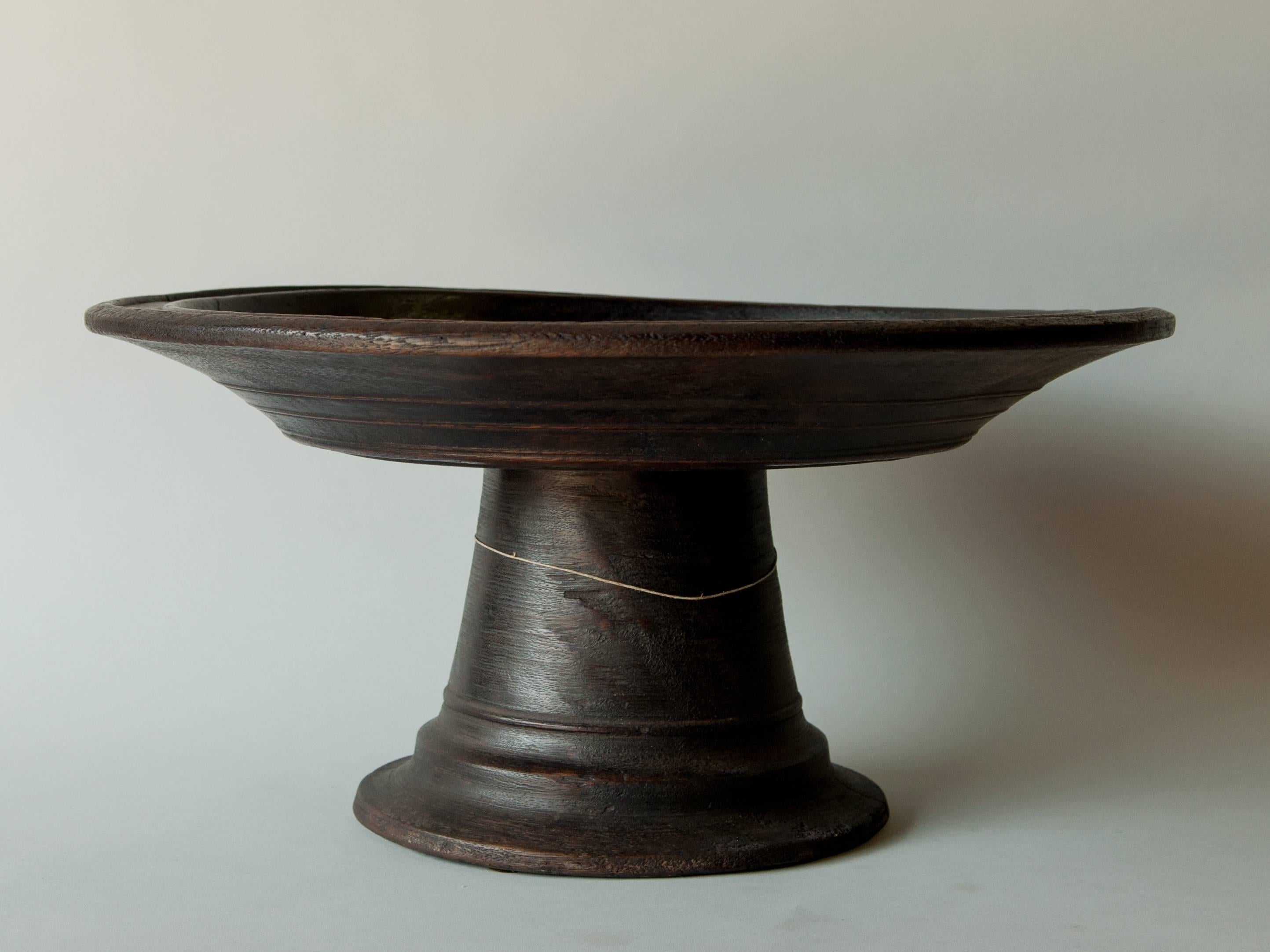 Wooden offering tray on stand, Lombok, Indonesia, mid-20th century.
Offered by Bruce Hughes.
This pedestal tray stems from Lombok, one island to the east of Bali, from descendants of Balinese who settled there beginning from the 18th century and