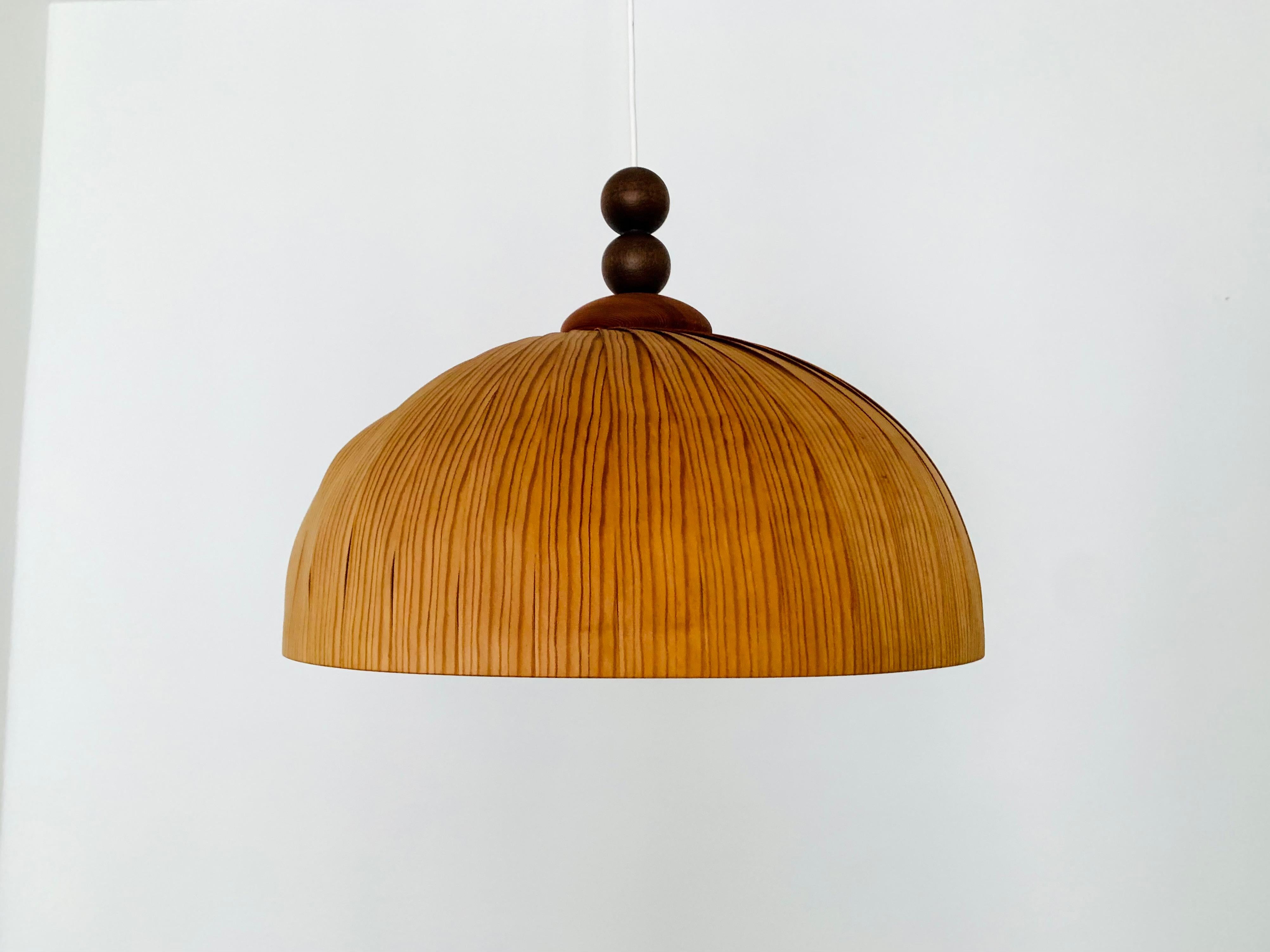 Extraordinarily beautiful wooden pendant lamp from the 1960s.
Loving and high-quality processing.
The design and the material create a very warm and pleasant light.

Condition:

Very good vintage condition with minimal signs of wear consistent