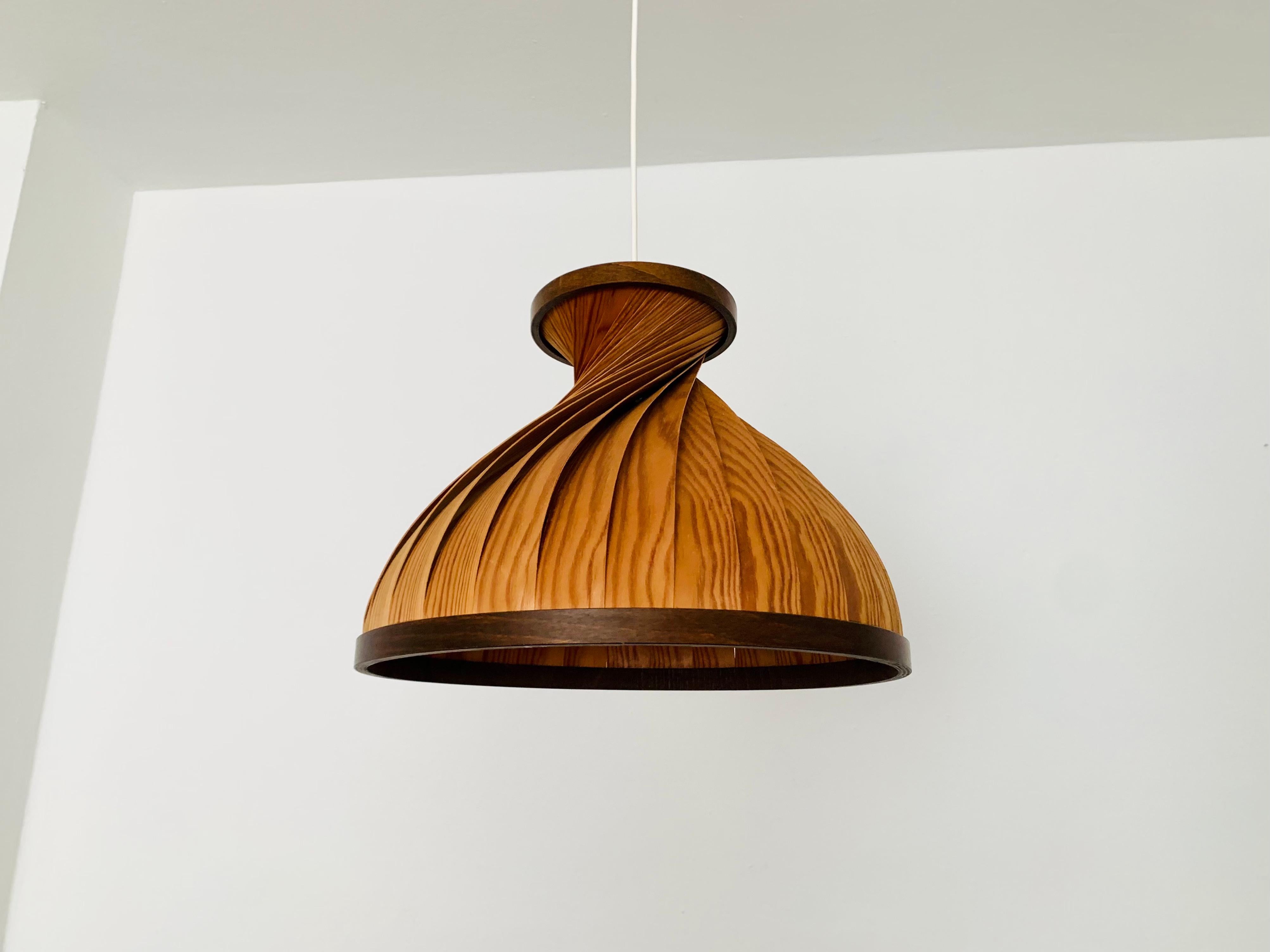 Extraordinarily beautiful wooden pendant lamp from the 1960s.
Loving and high-quality processing.
The design and the material create a very warm and pleasant light.

Condition:

Very good vintage condition with slight signs of wear consistent