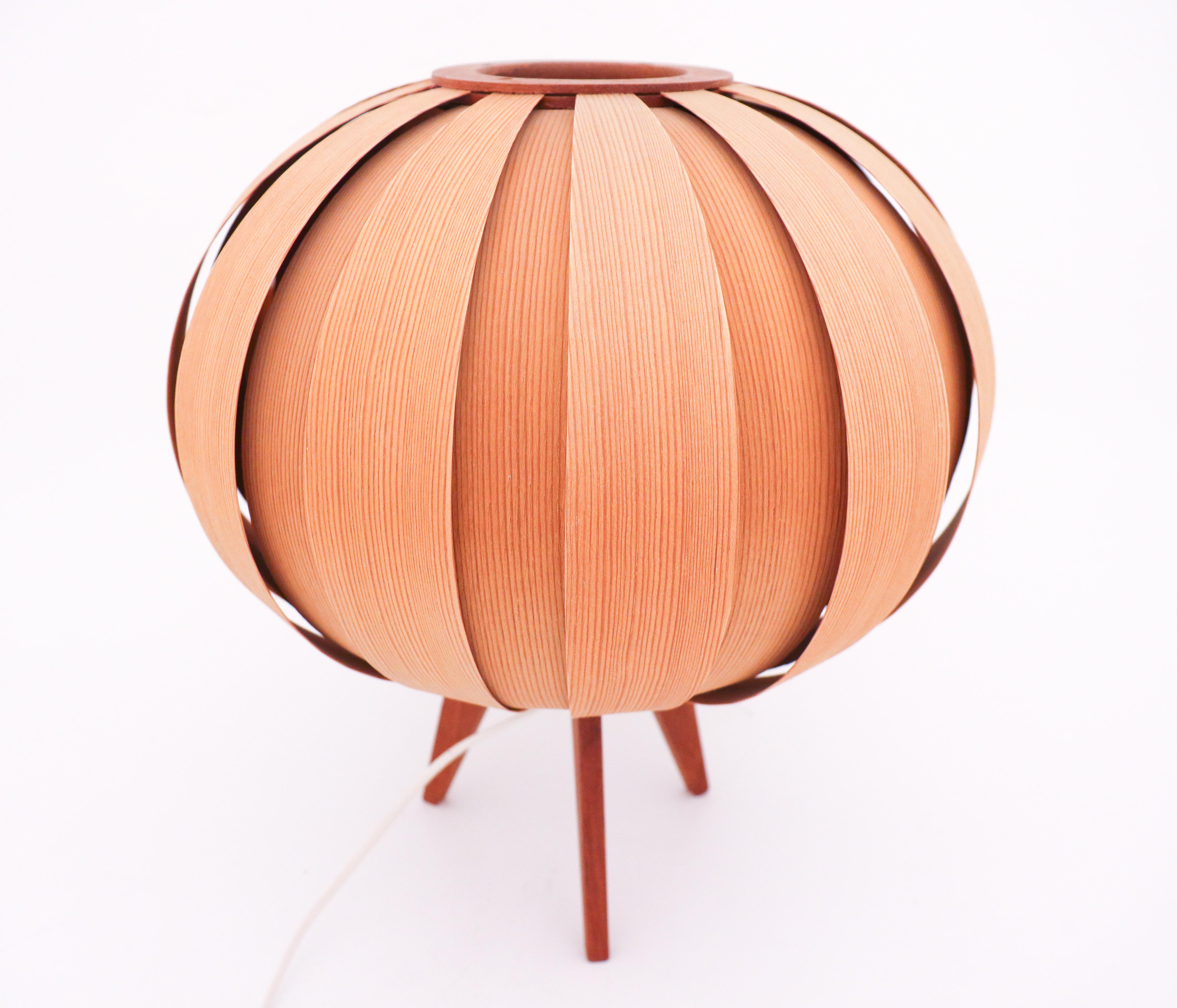 A bentwood lamp made in pine designed by Hans-Agne Jakobsson designed by Ellysett AB in 1960s. It is in very good condition.