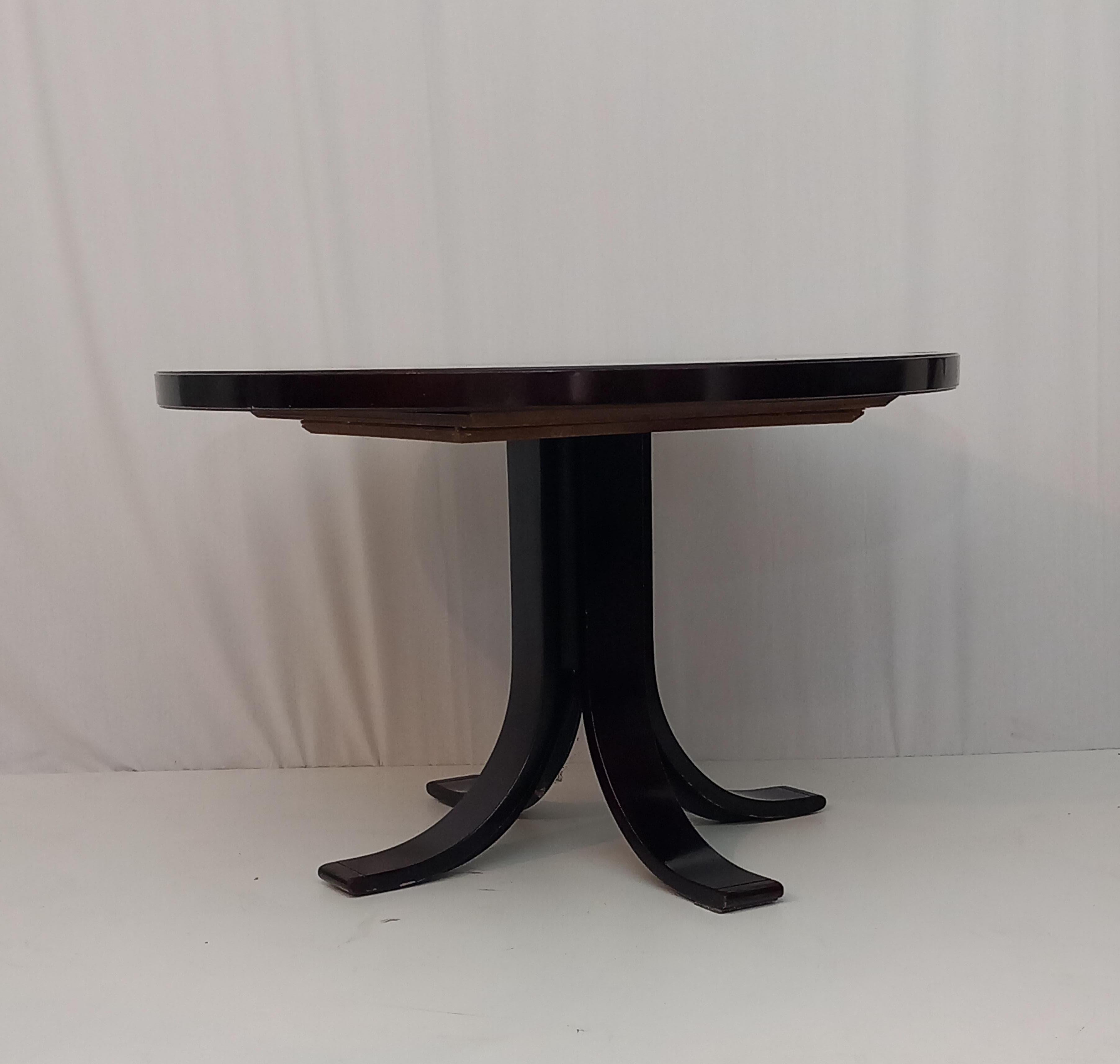 Step back in time with this vintage wooden round extendible table, created in the 1960s, blending timeless charm with everyday functionality. Crafted with care, this table features a simple, clean, yet elegant design that feels both stylish and