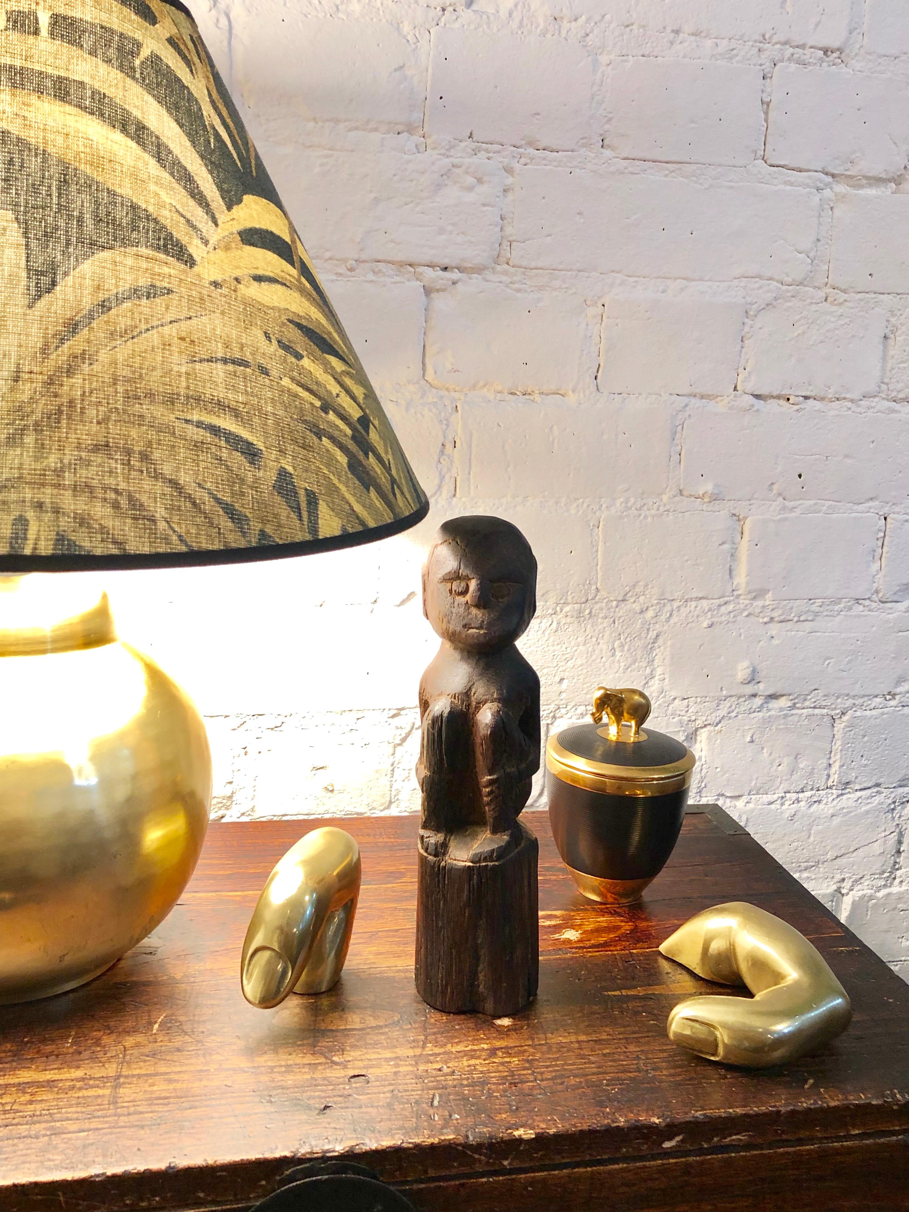 Wooden sculpture / carving of sitting figure from Sumba Island, Indonesia (circa 1970s-1980s). The island tribal creators of works like this one are anonymous. Often the age, origin and even use of the objects are unknown as well. Notwithstanding