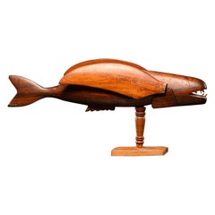 Wooden sculpture Pitcairn Flying Fish on museum stand.