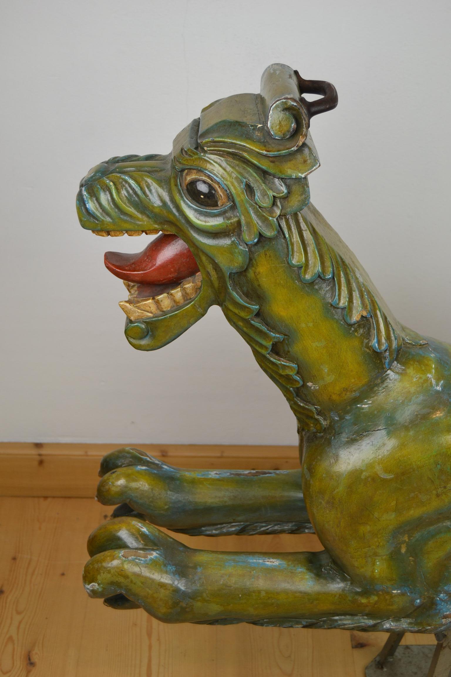 Vintage wooden sculpture of a Sea Dragon used on the carousel or roundabout. 
This Carousel ride on animal dates circa 1950s. It's carnival art of a cute looking dragon with very beautiful colors. He's still in original painting and on a metal