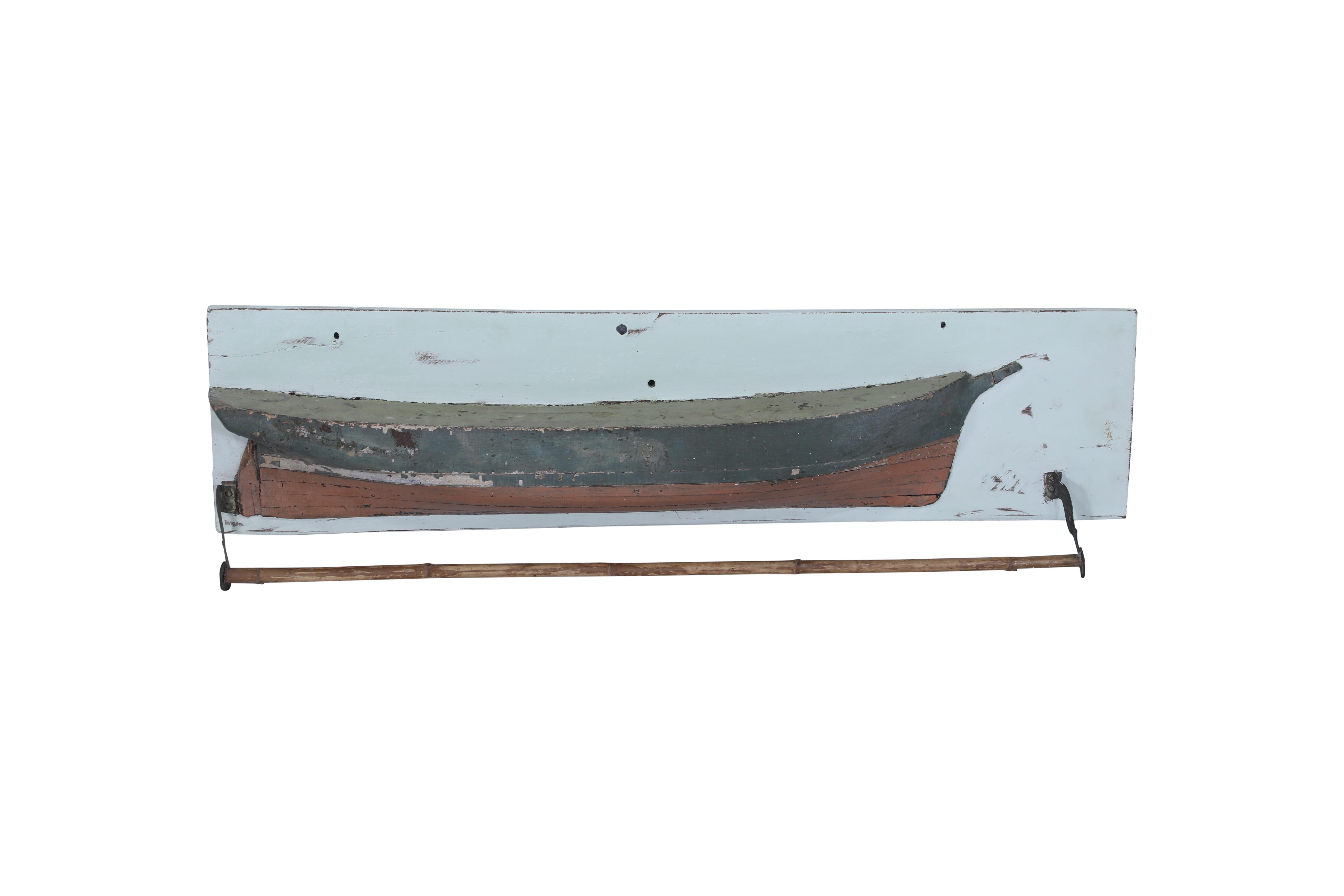 A wooden ship's half hull with original paint and patina.  The top part of the boat could be used as a shelf for small items and measures 3.5