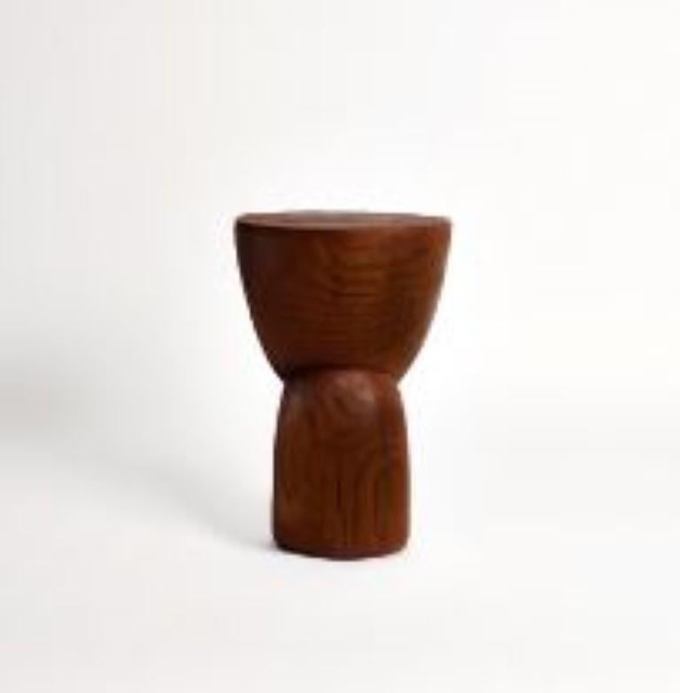 Wooden side table in Darker Brown by Project 213A
Dimensions: D 30 x W 30 x H 43.5 cm
Materials: Solid wood. 

This sculptural side table is hand carved by local artisans in Portugal using solid wood. Available in natural or darker brown