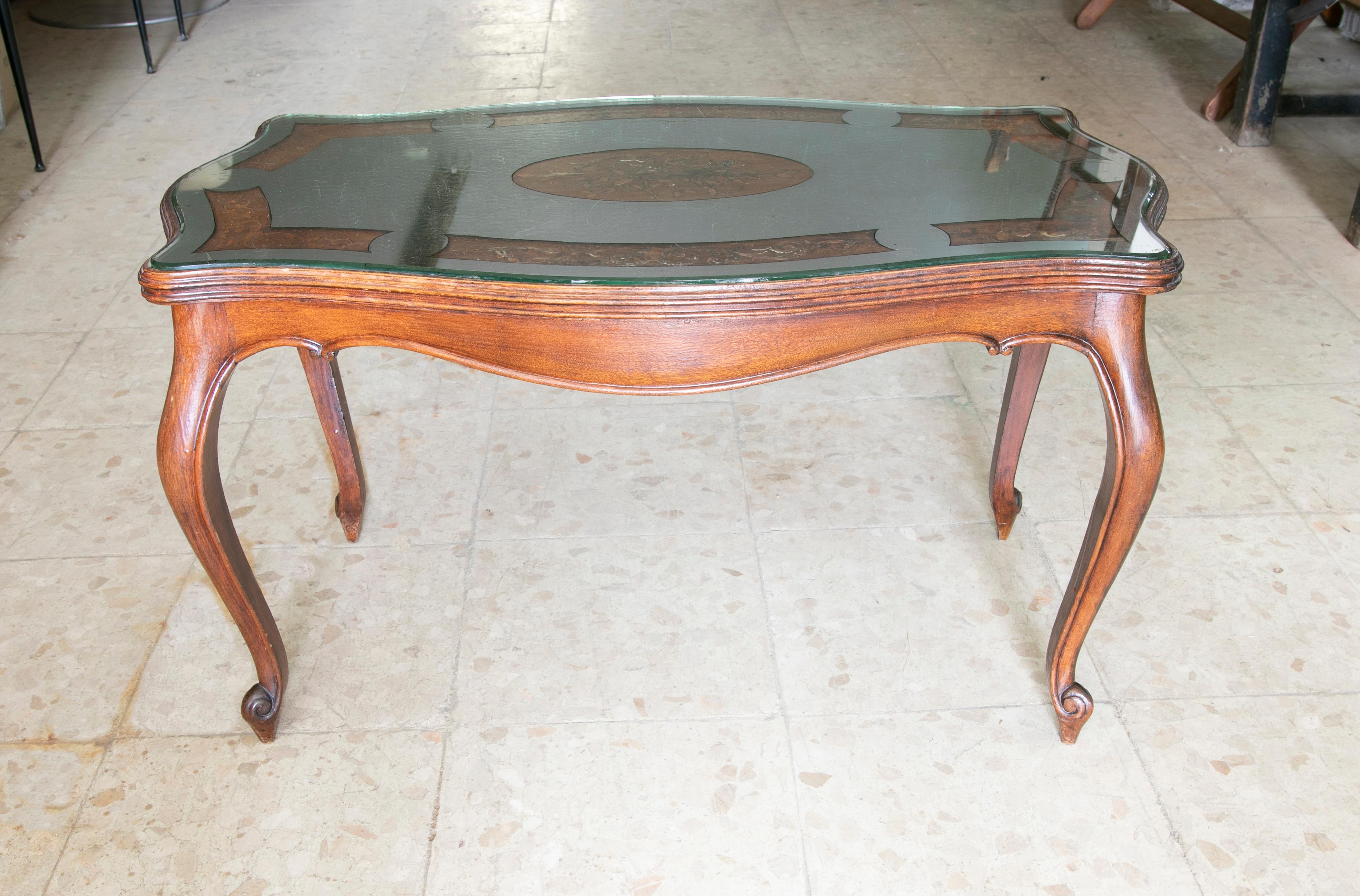 Wooden side table with inlaid top and mirrored top.