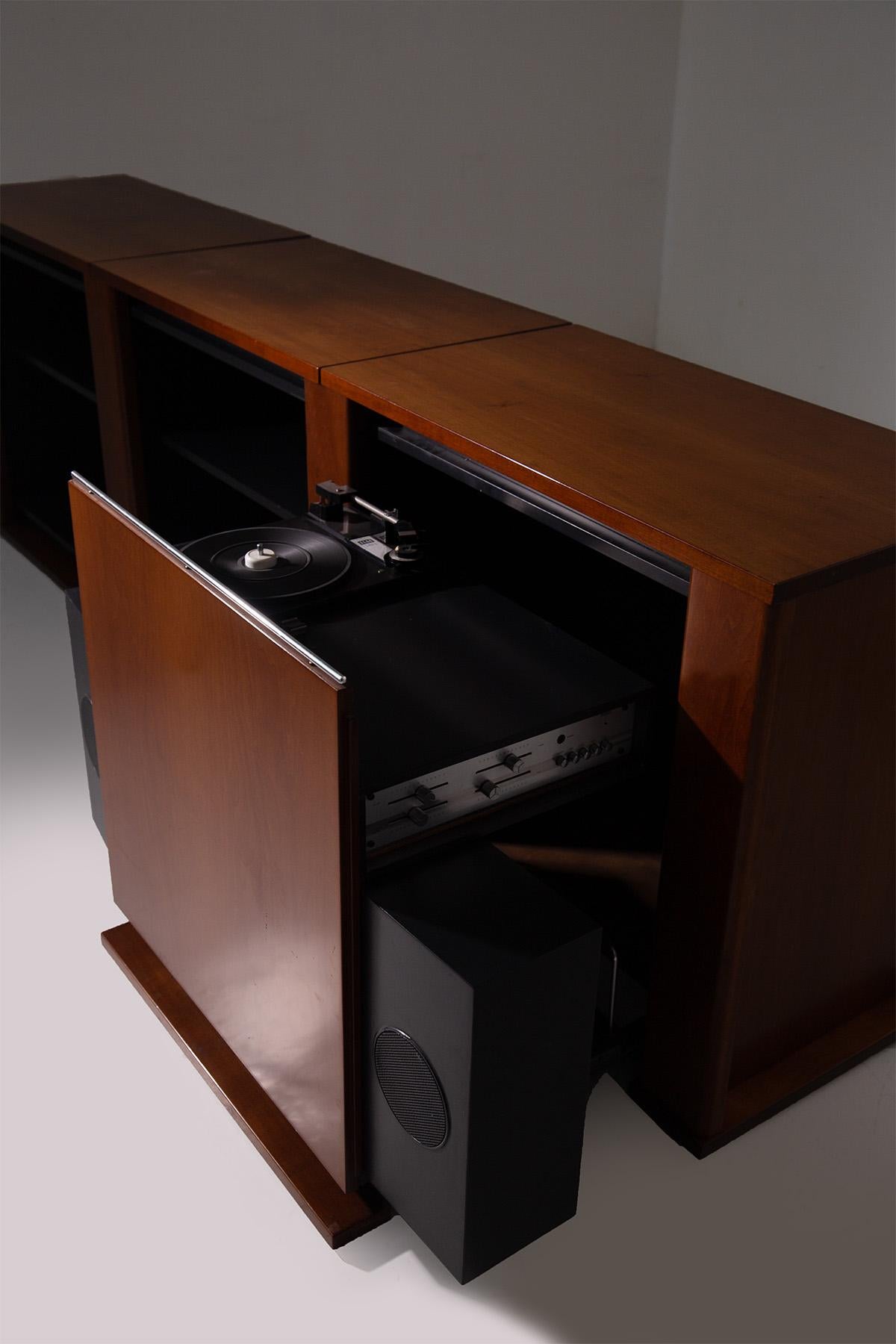 This stunning piece of fine wood furniture immediately captures attention with its elegant simplicity and meticulous craftsmanship, characteristic of Italian manufacturing from the 1970s. The linear, minimalist design is perfectly balanced by the