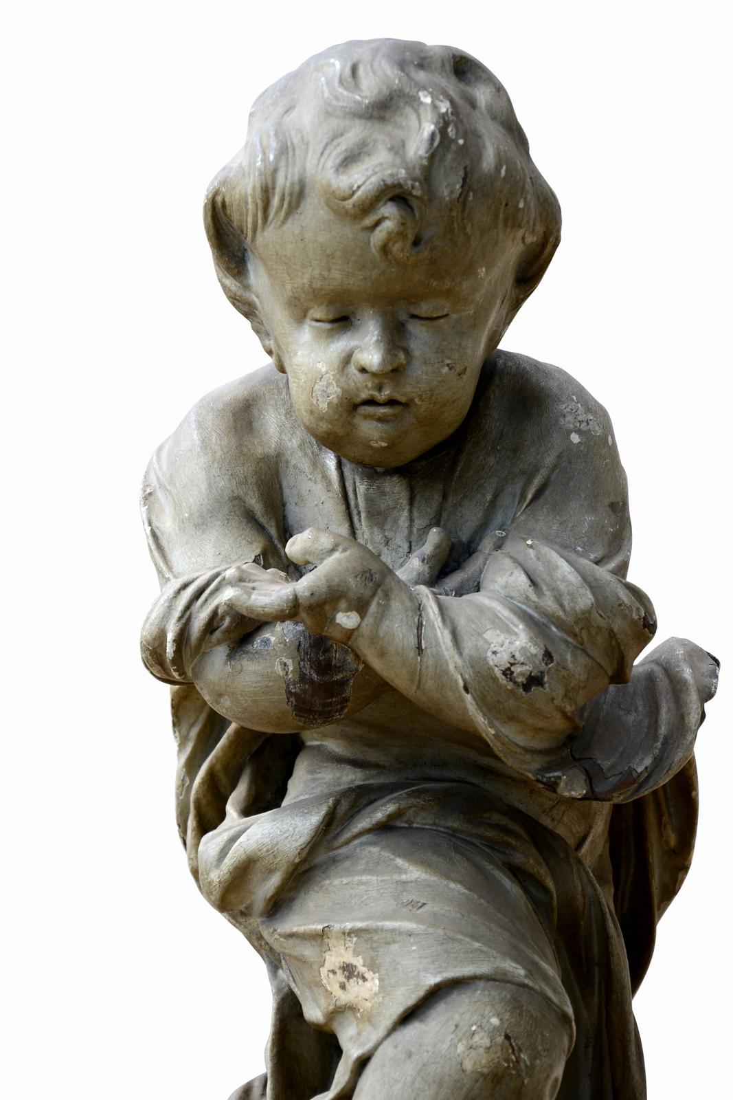 Dating from the 18th century, wooden statue representing Jesus as a child. Jesus is standing with his arms crossed over his chest but his hands are open to the front. His right foot rests on the terrestrial globe and crushes the head of a snake