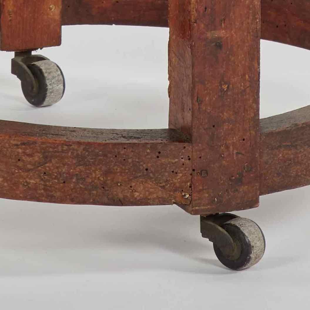 Late 19th-century French wooden stool with bone-colored linen upholstery. The circular seat is supported by four block-style legs connected by a circular base set on casters. An easy, functional piece with an air of country chic. 

France, circa