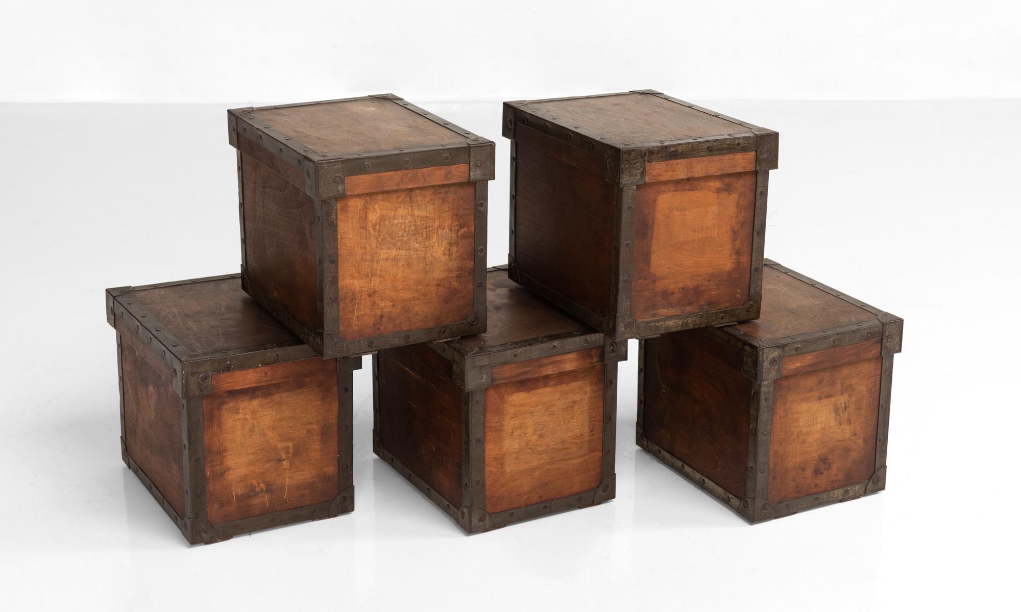 Wooden storage box with metal edges, England, circa 1930.

Wooden boxes with wooden lids and protective metal edges.