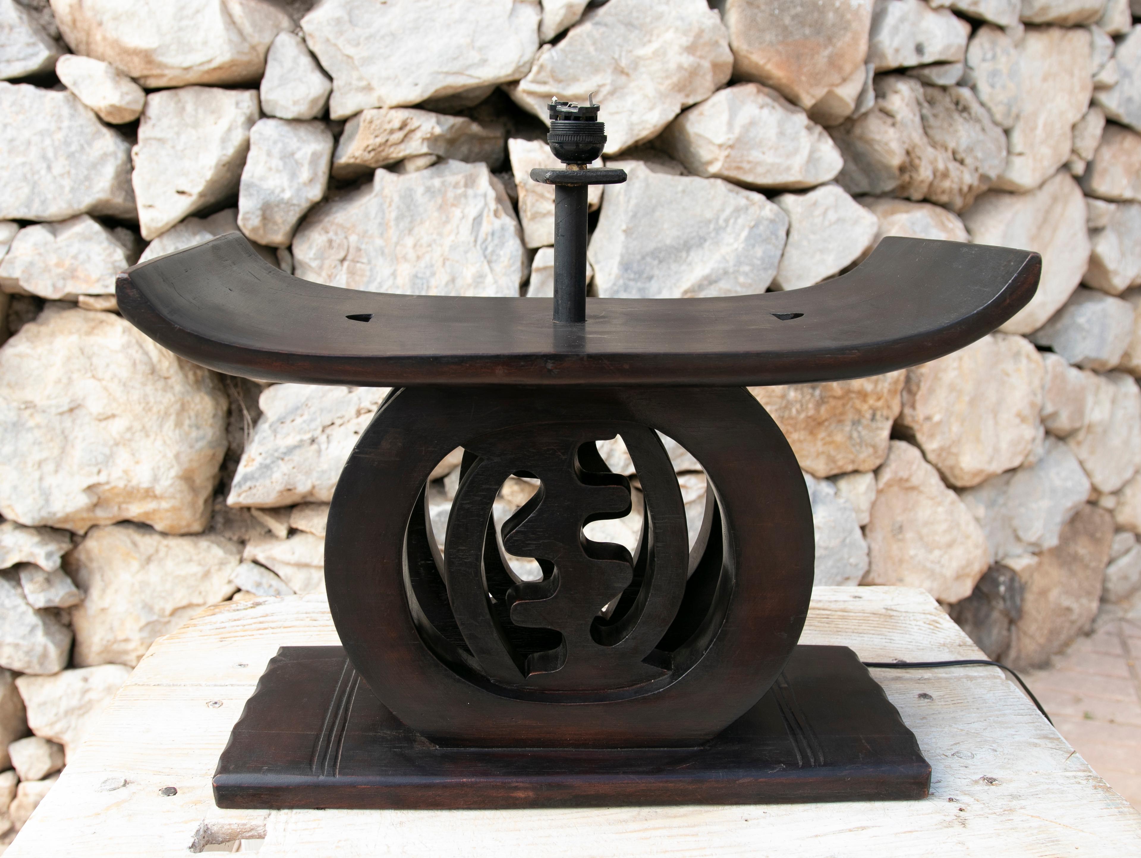 Wooden table lamp with Japanesque shape.