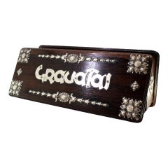 Wooden tie box with silver “Ties” cutout and floral motifs