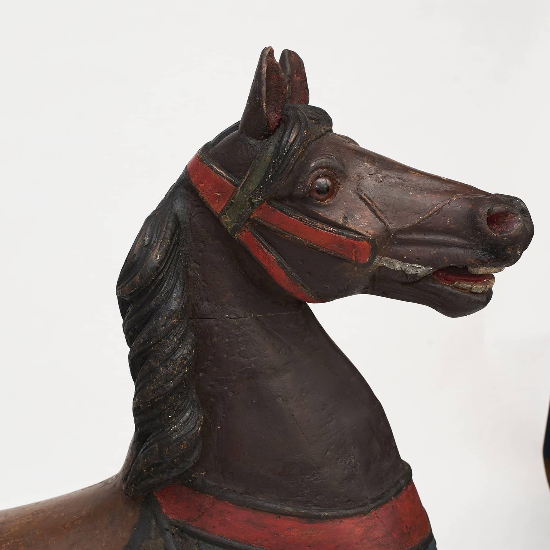 Wooden carousel / merry-go-round horse made for the first carousel in Tivoli, Copenhagen, c. 1840-1850.
Hand carved with nice details, glass eyes and a real horse hair tale.
With its original coats of decorative paint, professional