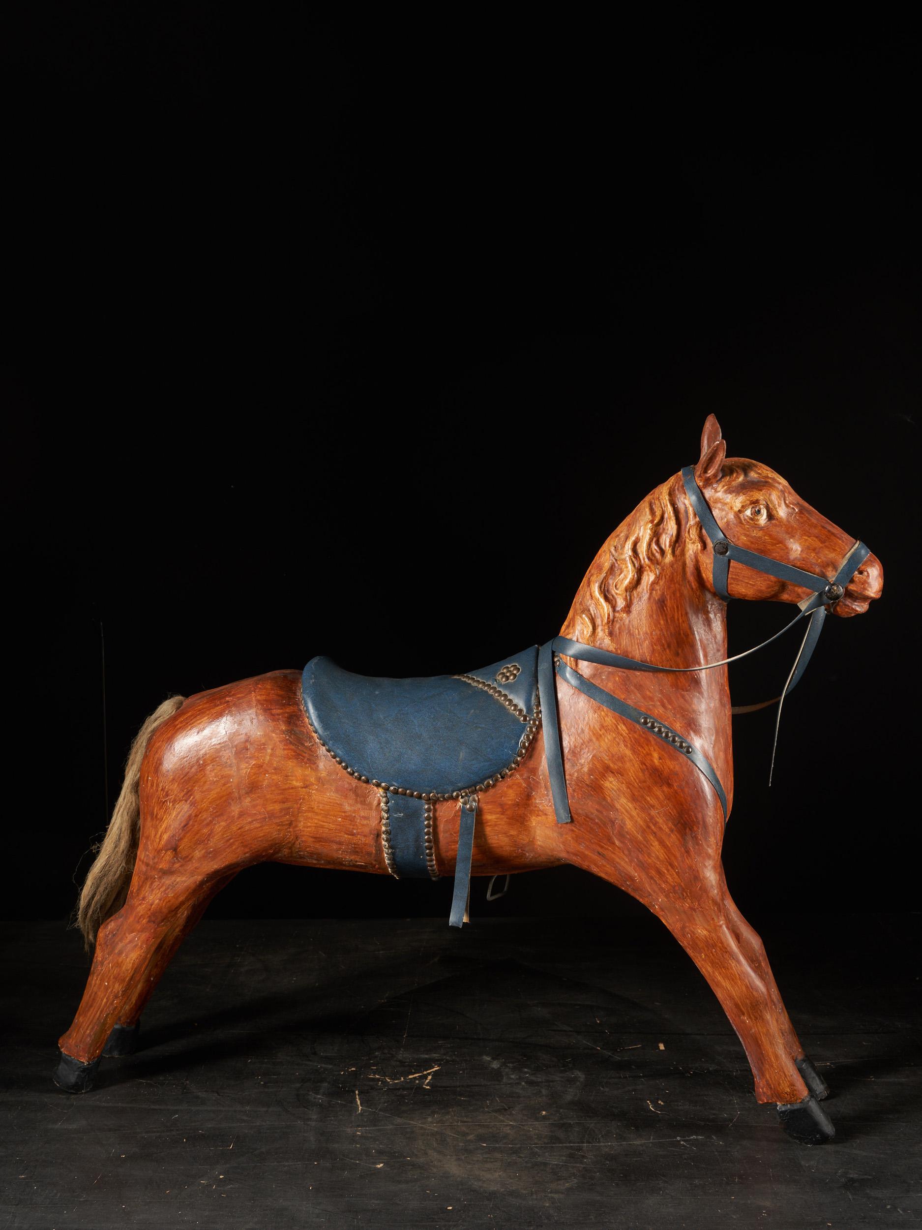 Painted wood and saddlery in artificial leather fixed with copper decorative nails.