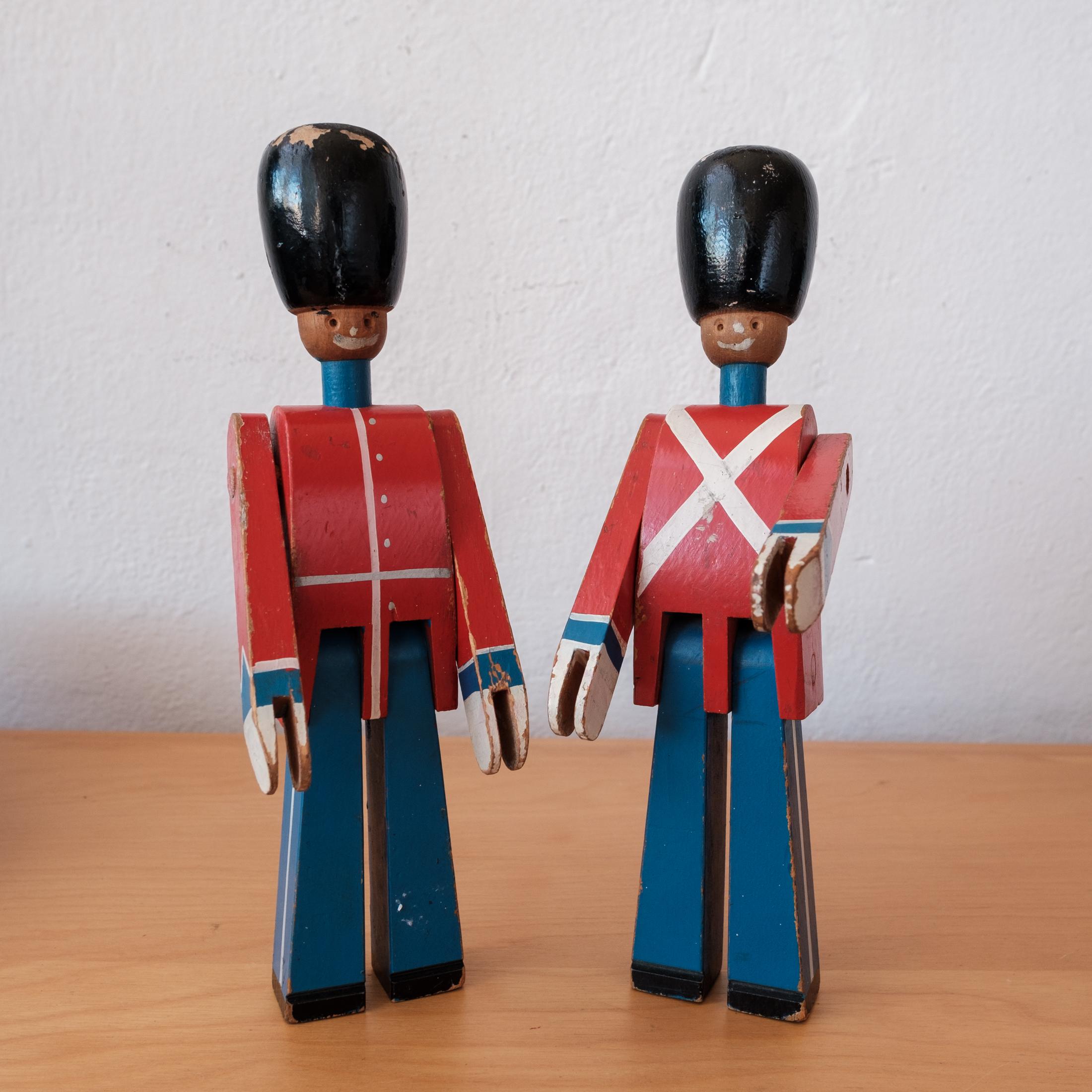 A pair of Royal guardsmen designed by Kay Bojesen. Each soldier Includes a 1950s Magasin du Nord labels. Lovingly used with lots of patina. Denmark, 1950s.