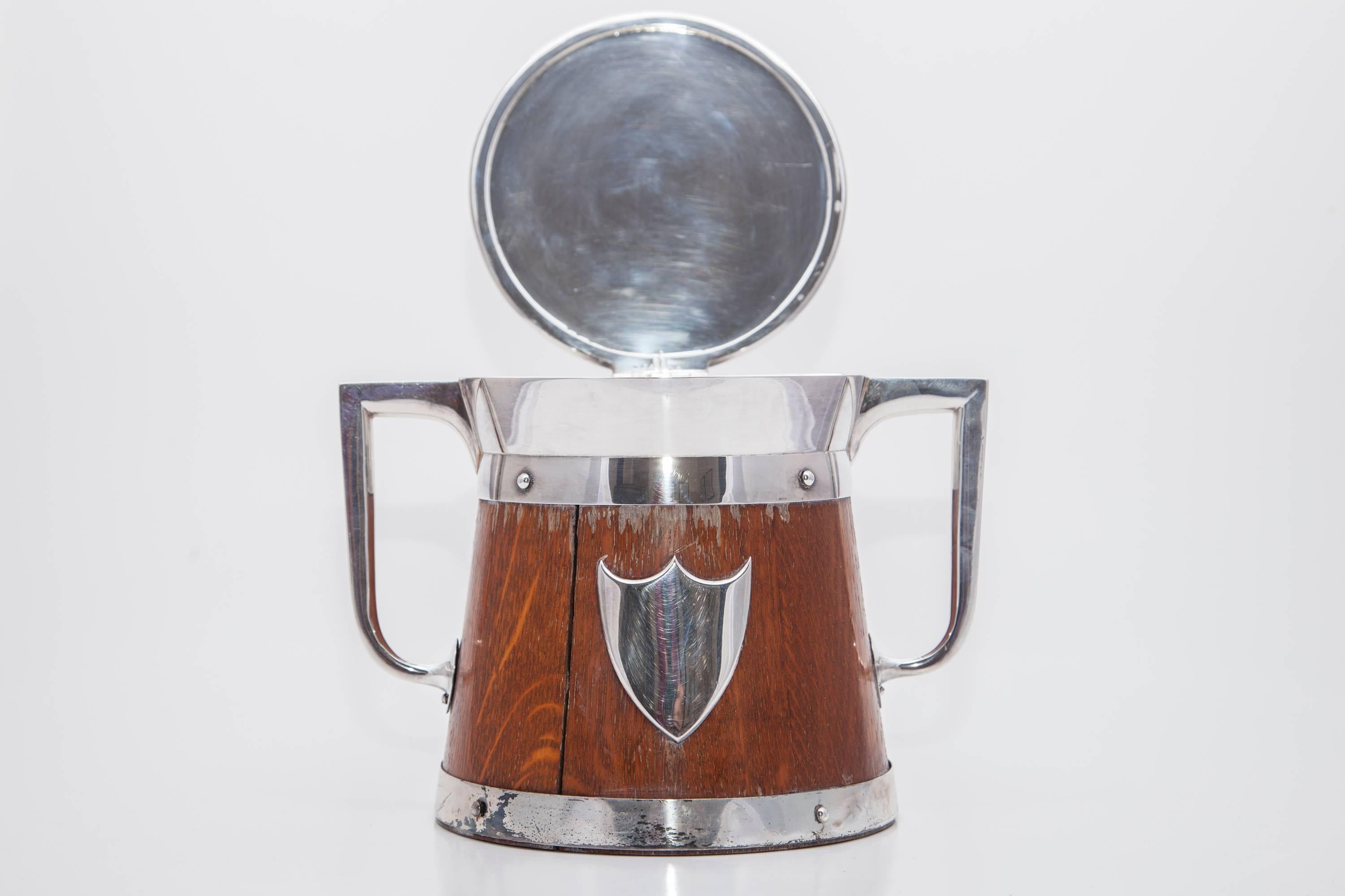 19th Century Wooden treen ice bucket with silver crest embellishment. The ice bucket has a porcelain liner. 