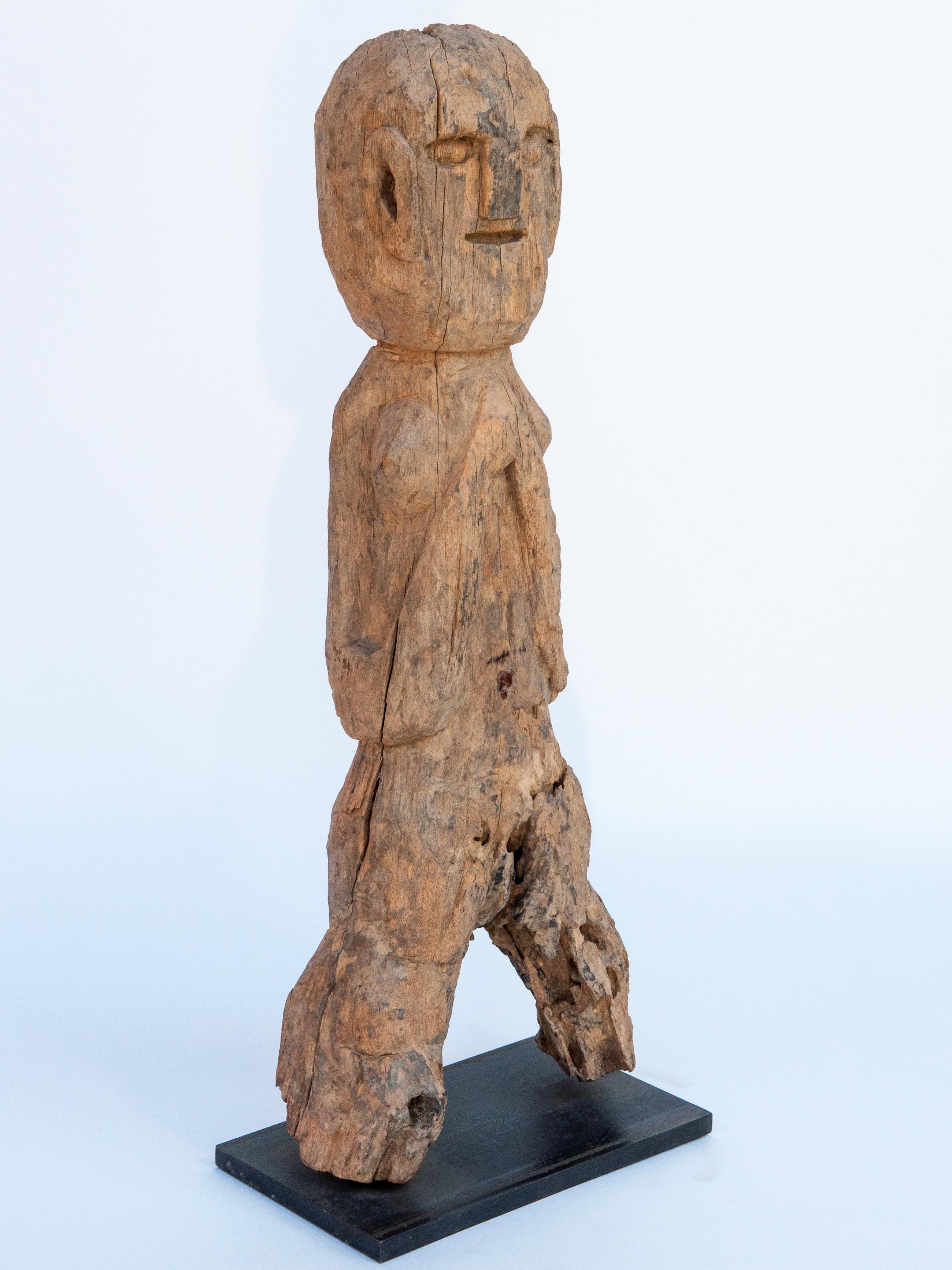 Wooden tribal female statue from West Nepal, early to mid-20th century. Mounted on a metal plate.
This wooden figure comes from West Nepal, most probably from the area of the Karnali river system. There is some mystery to these sculptures, which are