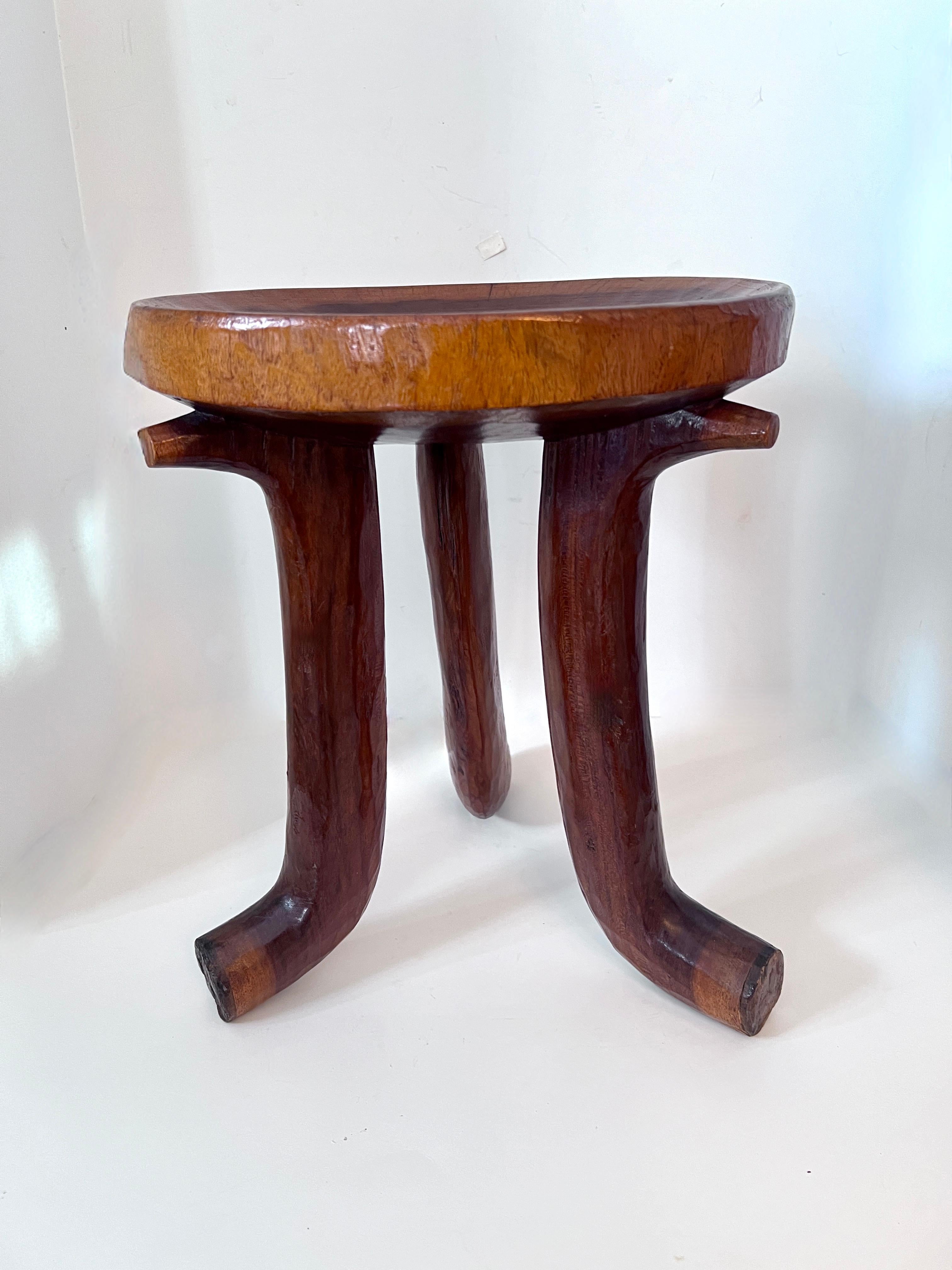An African, Ethiopian three leg table or Oromo stool.  The solid wood piece is a compliment and unique style stool or side table.  The stool, in it's original state was for the elders to sit, in todays setting it adds a sense of organic