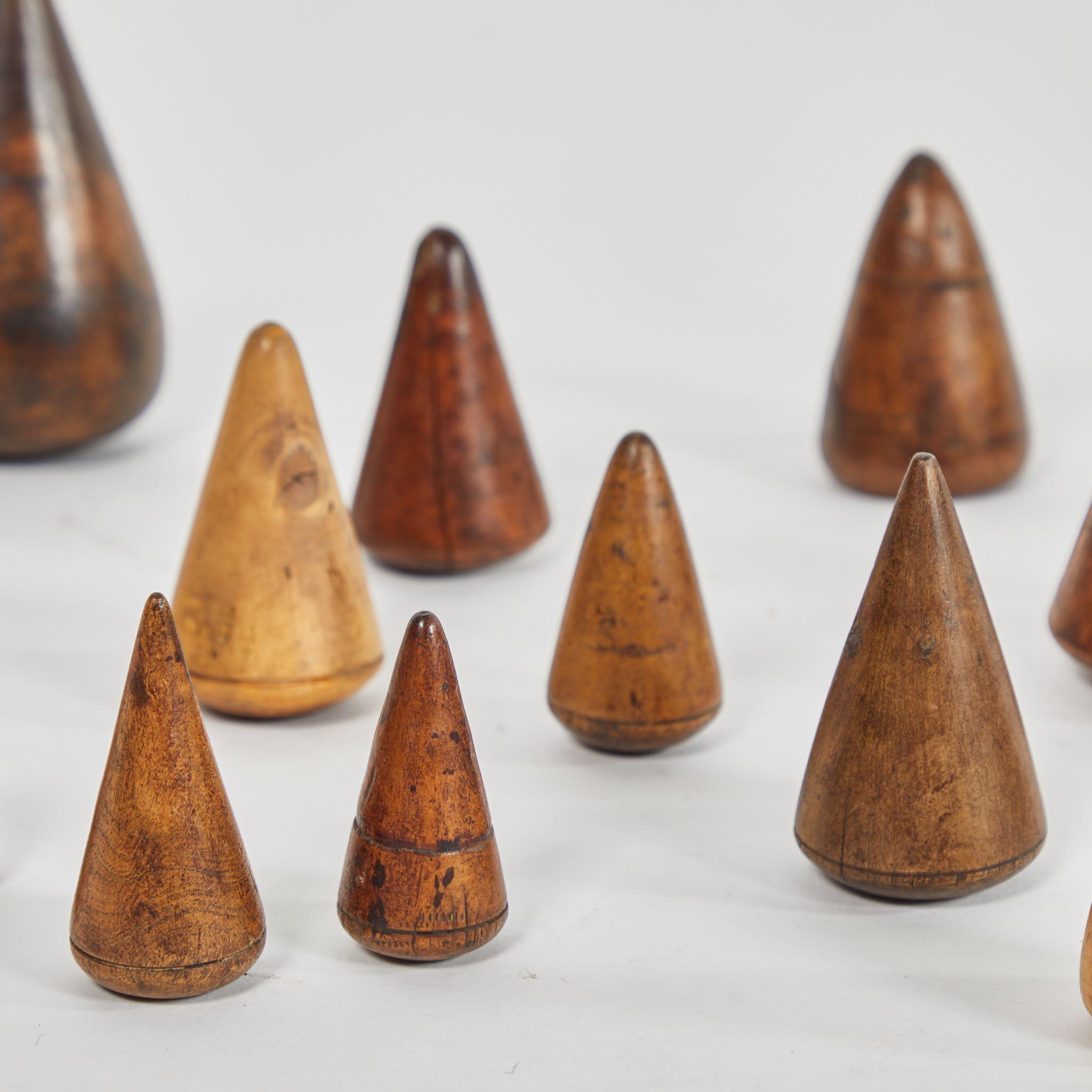 A series of 14 wooden turn-pins, originating in England, circa 1880.