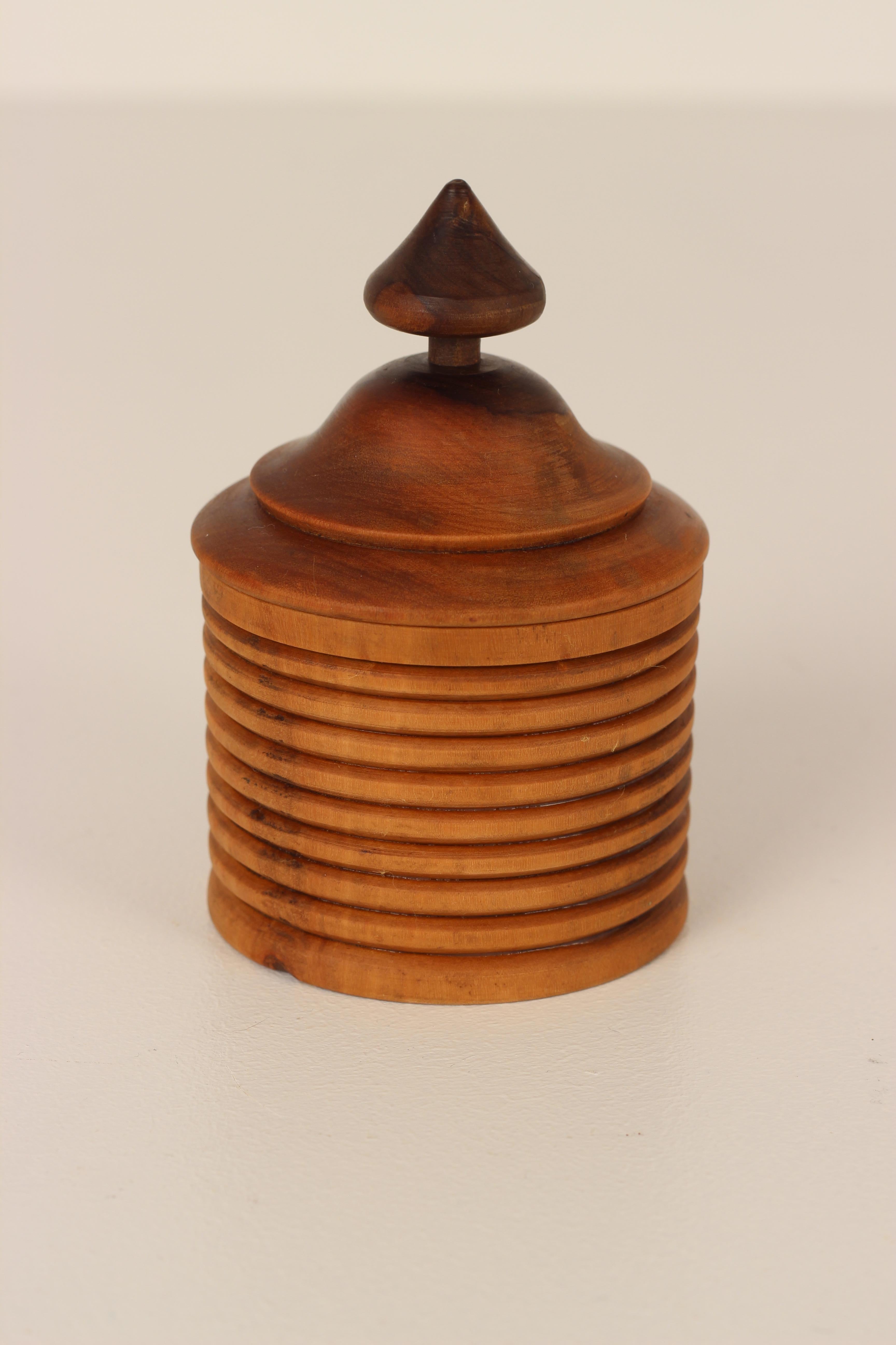A skilfully crafted piece of turned treen with an interesting silhouette. The piece opens into two sections leaving an interior space to prize, hide or store a treasure or two. There is a feeling of the Grand Tour about it, with the top resembling a