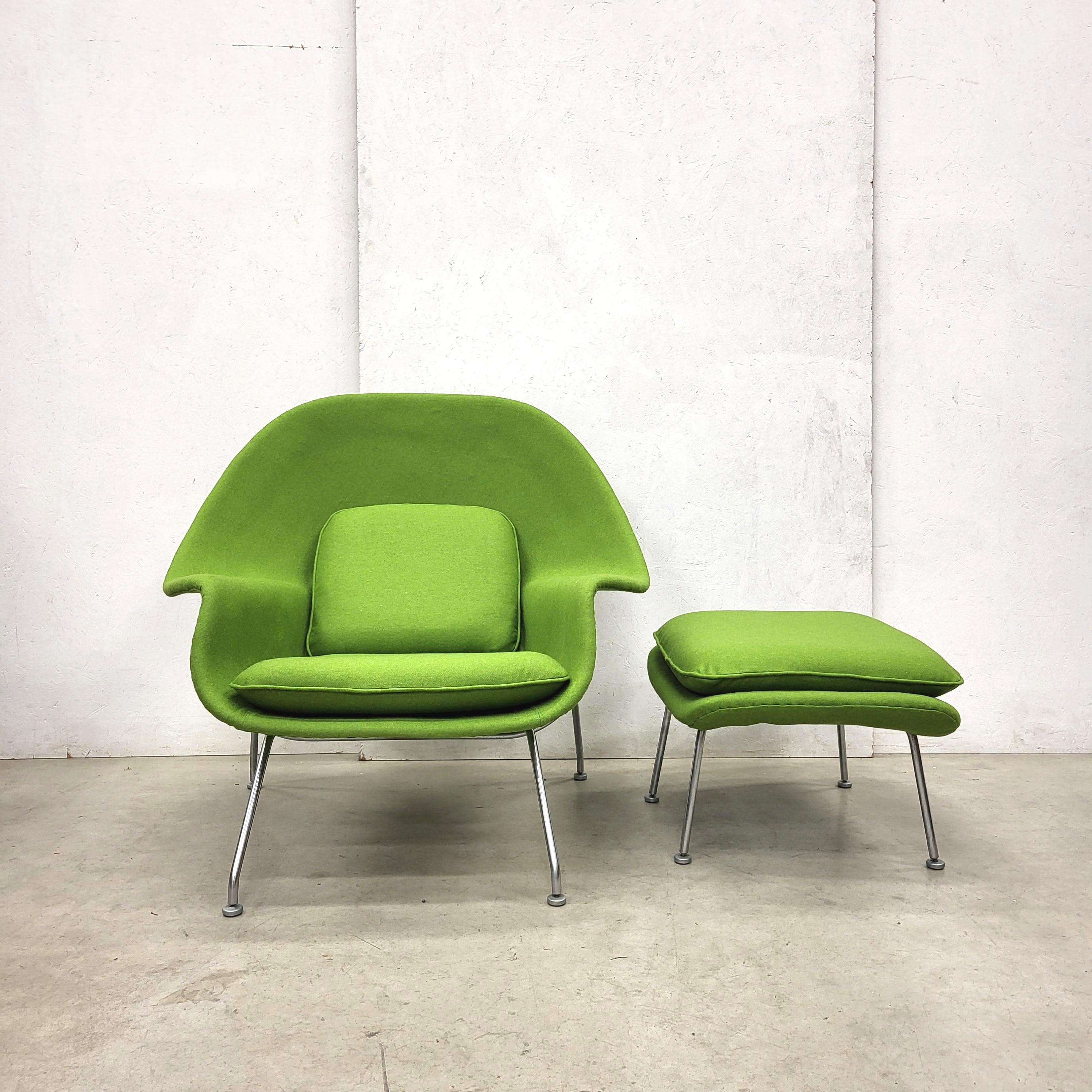 Early Woodwood Green Womb chair and ottoman by Eero Saarinen for Knoll. 

The groundbreaking Womb chair was designed in 1948 by Eero Saarinen at Florence Knoll's request for 