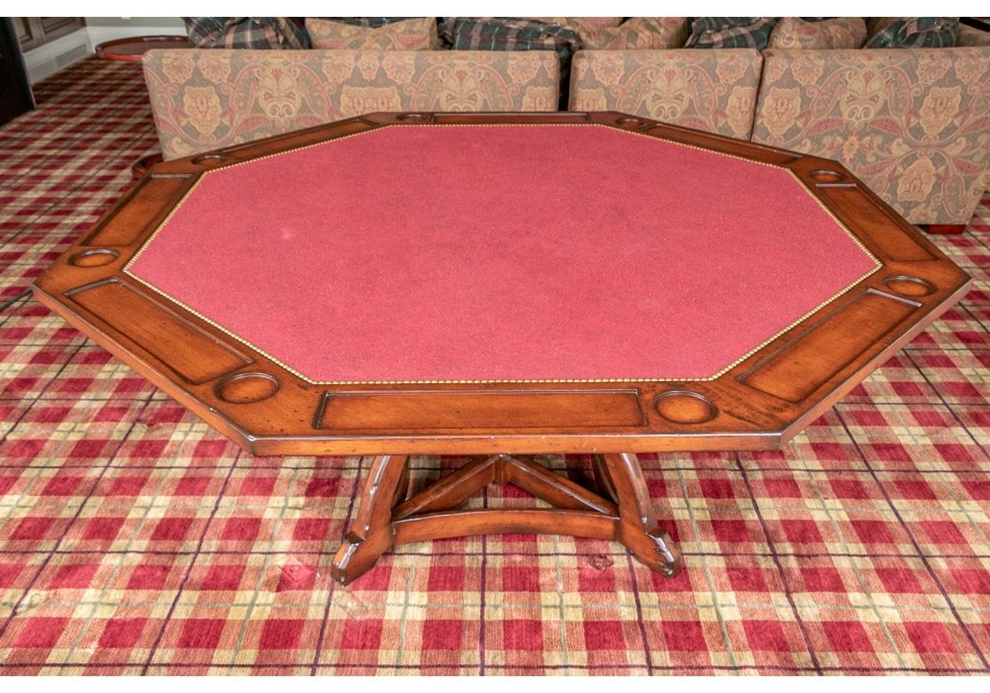 Fine and large Woodland Furniture octagonal custom game table with lined top, indents for cups and playing pieces. The top rhythmically decorated with brass tacks, resting on an arch and X-form pedestal base with styling as in a Gothic Vault.